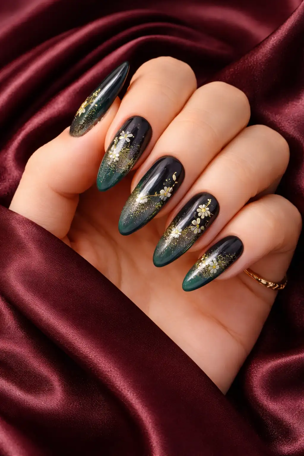 dark green ombre nail design with gold floral details and glossy finish