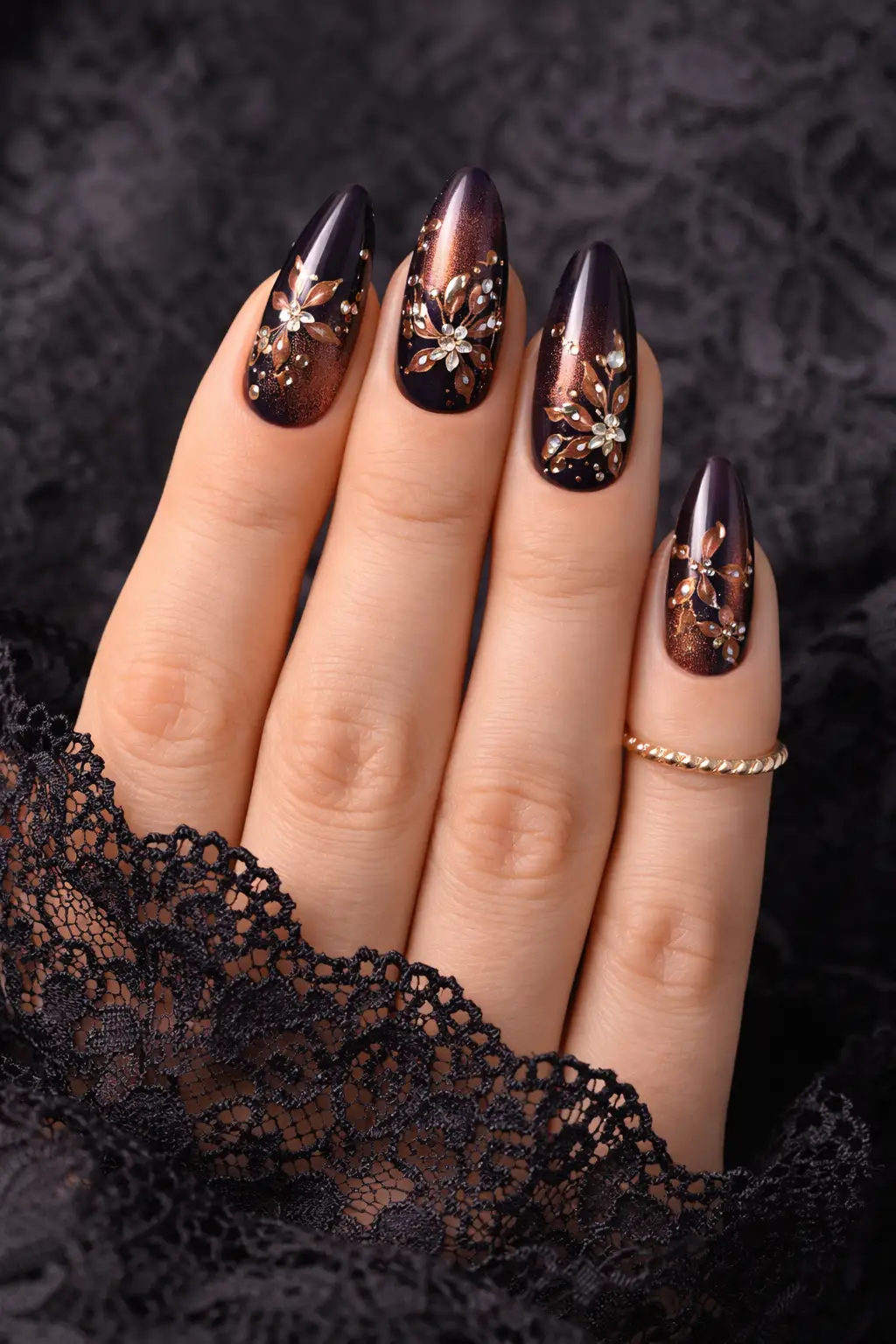 dark brown shimmer nail design with gold floral details and glossy finish