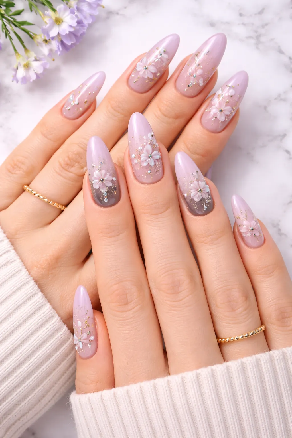 soft lavender floral nail design with light glitter and crystal details