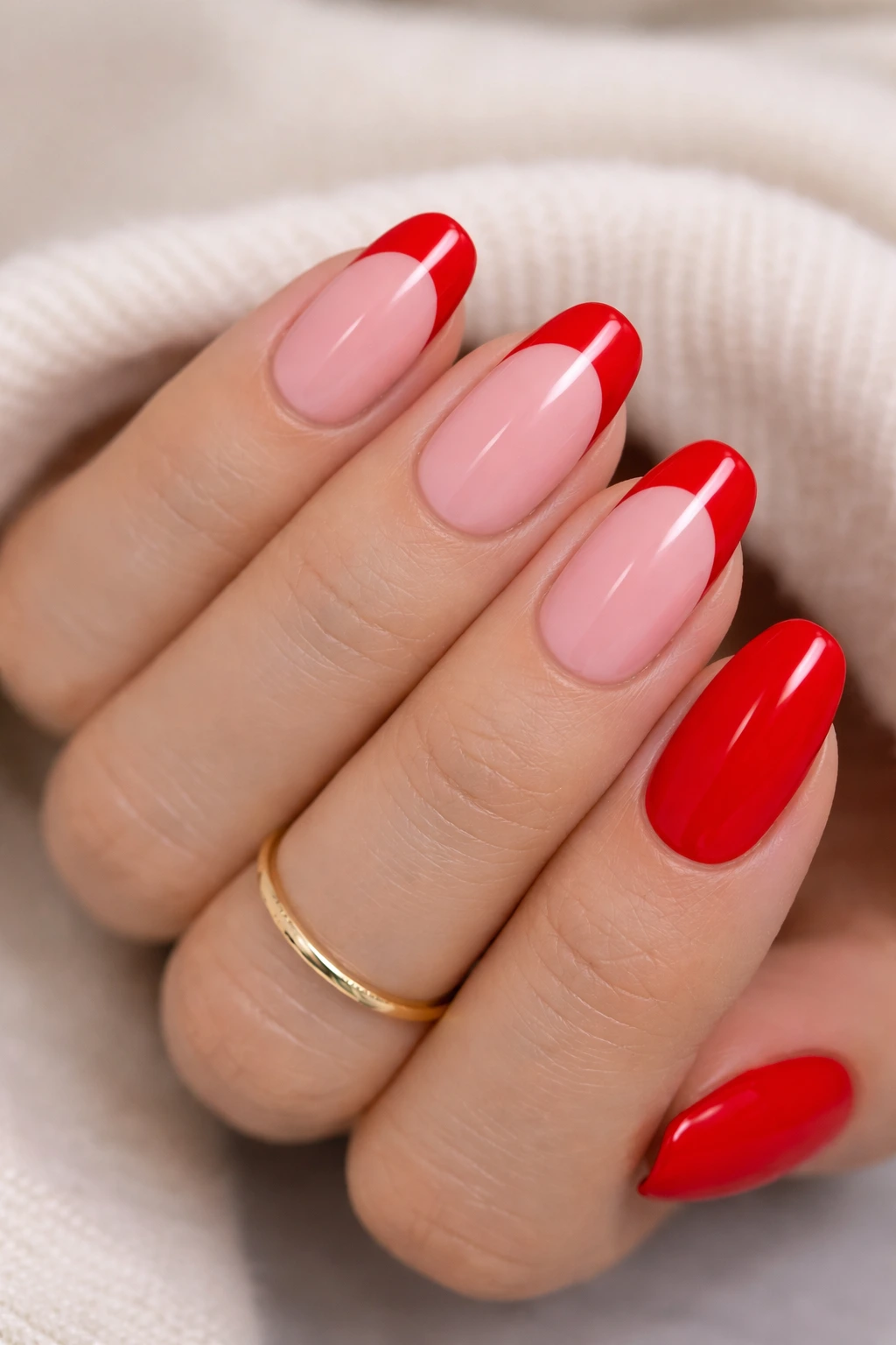 Red French tip Valentine nails with nude pink base and glossy finish