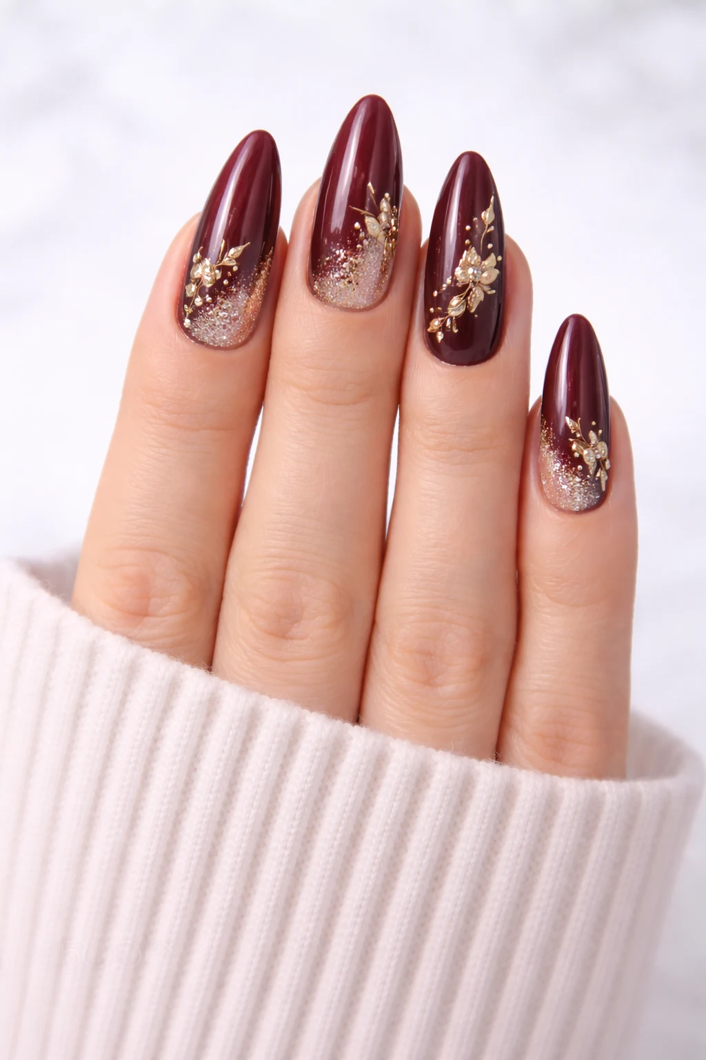 burgundy ombre nail design with gold floral details and glossy finish