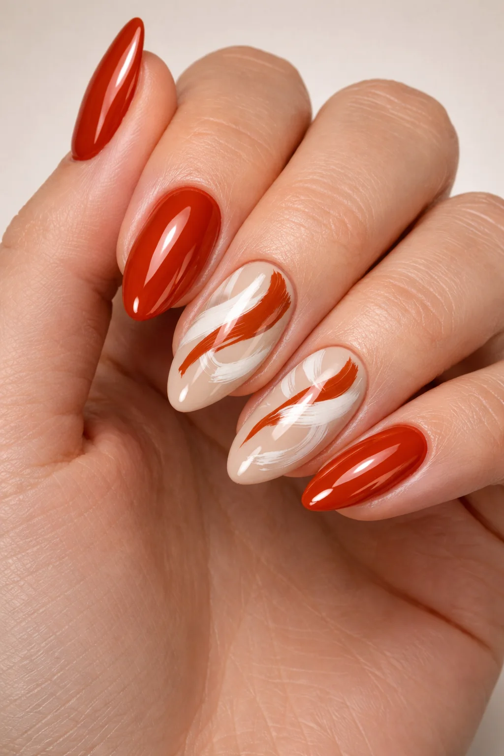 Rust orange nails with abstract swirl patterns glossy warm toned summer manicure design