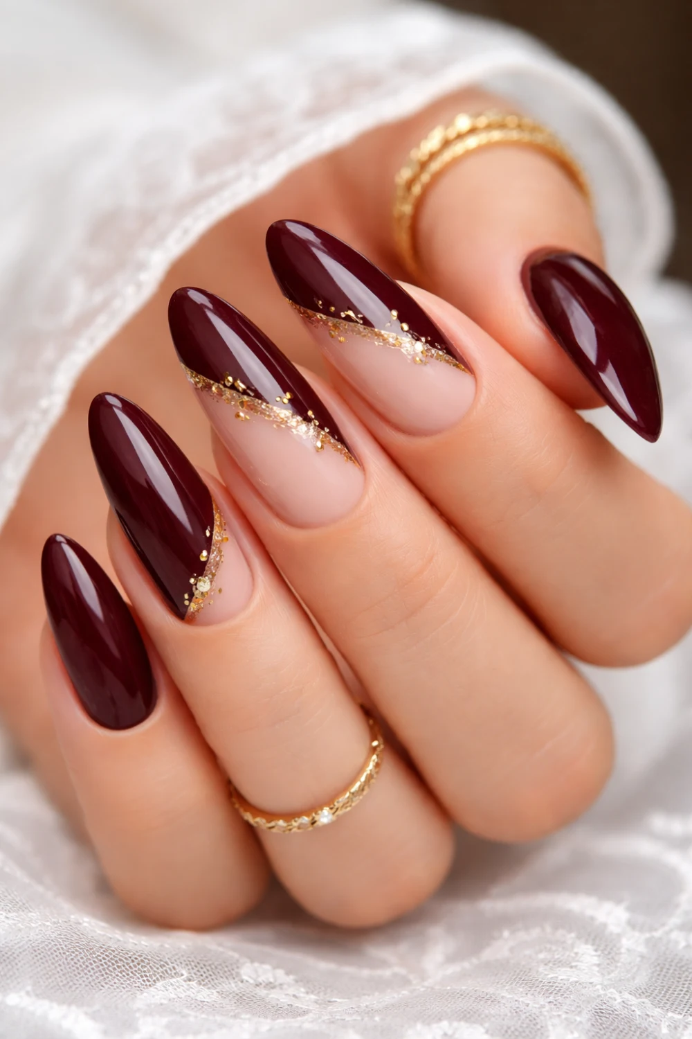 deep maroon gold wave gel nails for eid, glossy wine manicure with glitter accent, luxury pakistani nail design