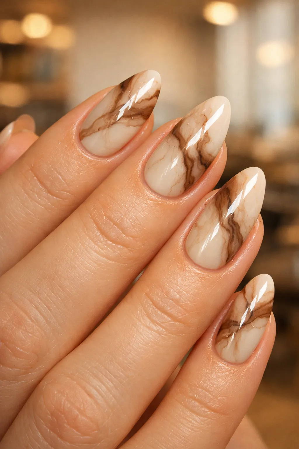 Nude nails with brown marble swirl patterns elegant stone texture nail art classy summer manicure