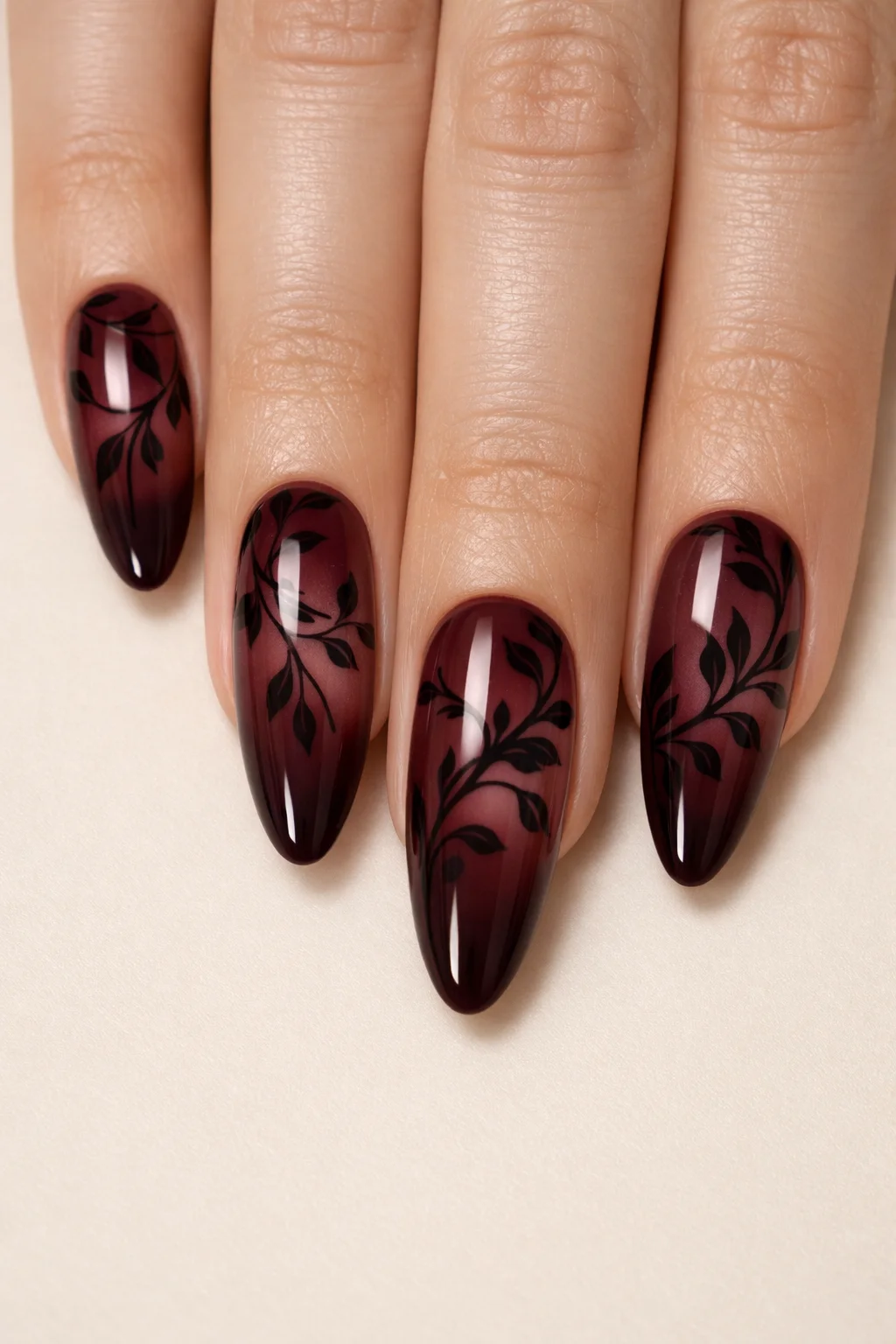 Burgundy vine blooming gel nail art with dark red glossy finish