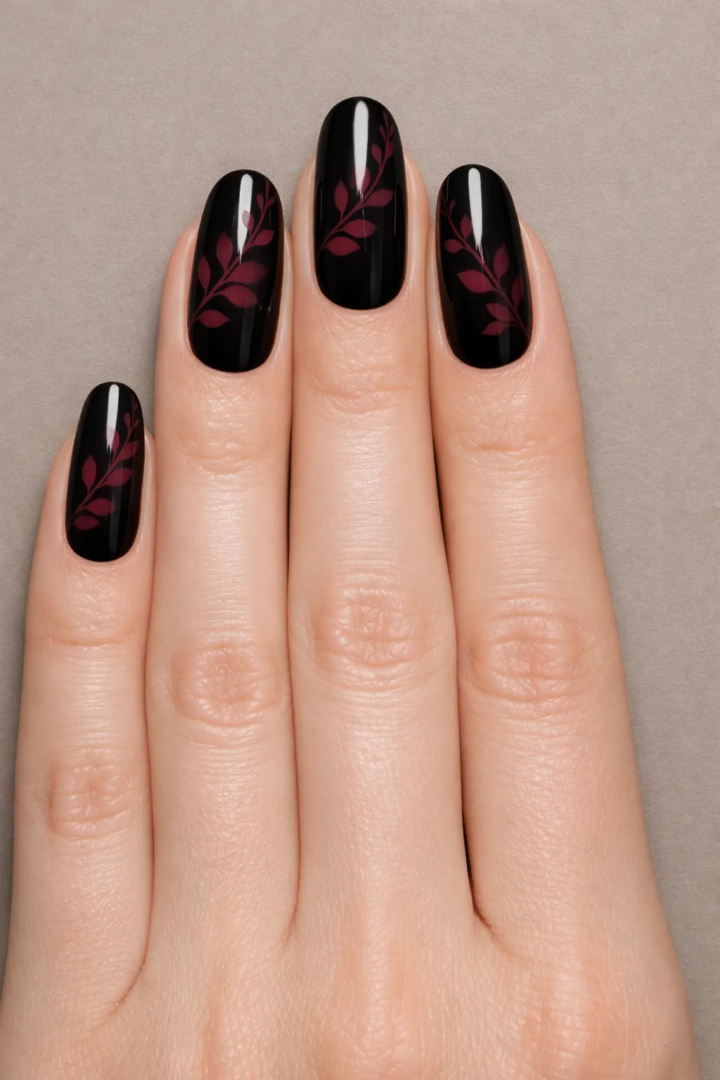 Glossy black blooming gel nail art with burgundy leaf pattern manicure