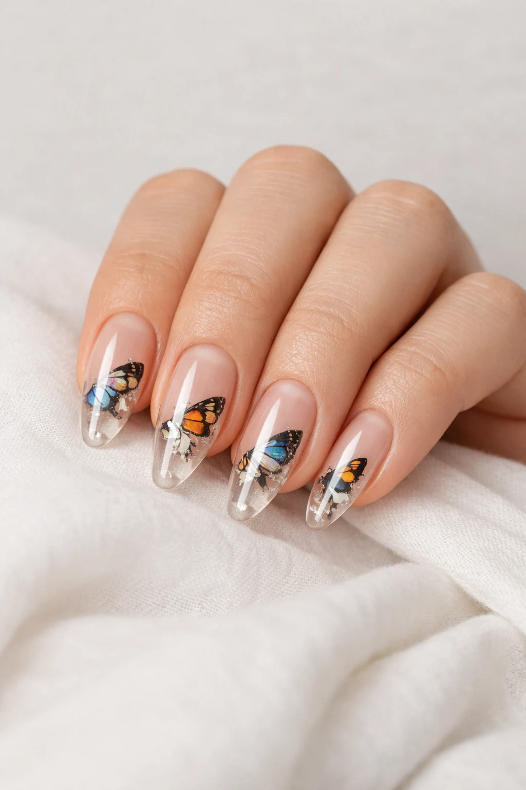 Transparent butterfly blooming gel nail art with clear tips nude base manicure