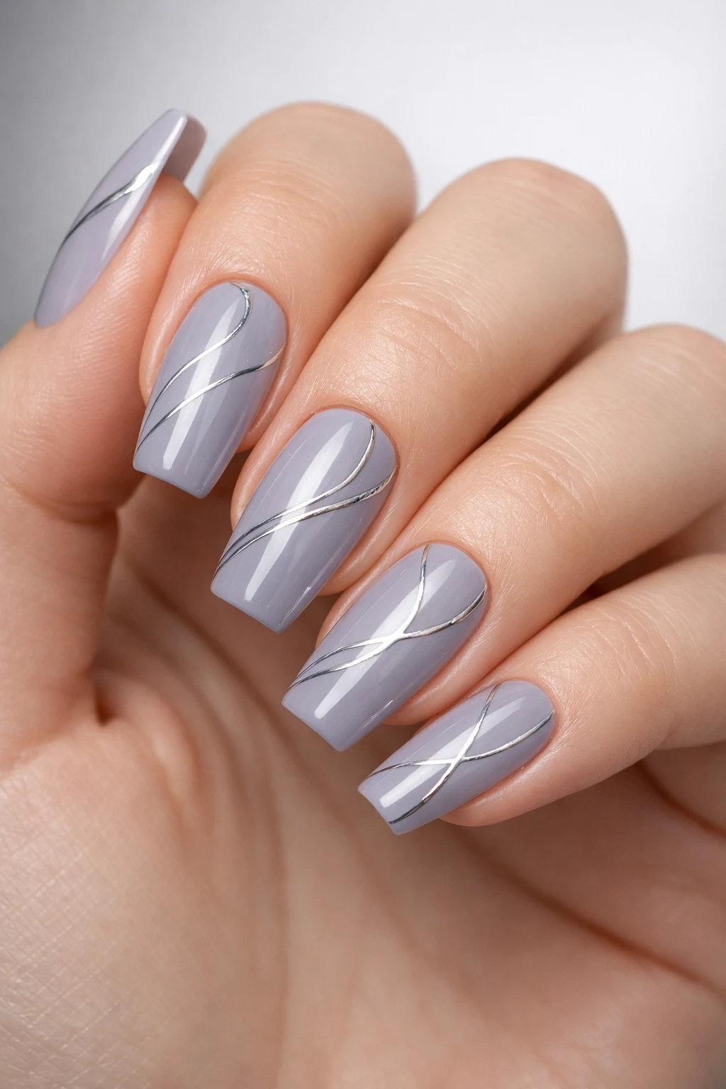 Grey glossy nails with thin silver chrome stripes sleek modern minimalist summer nail art design