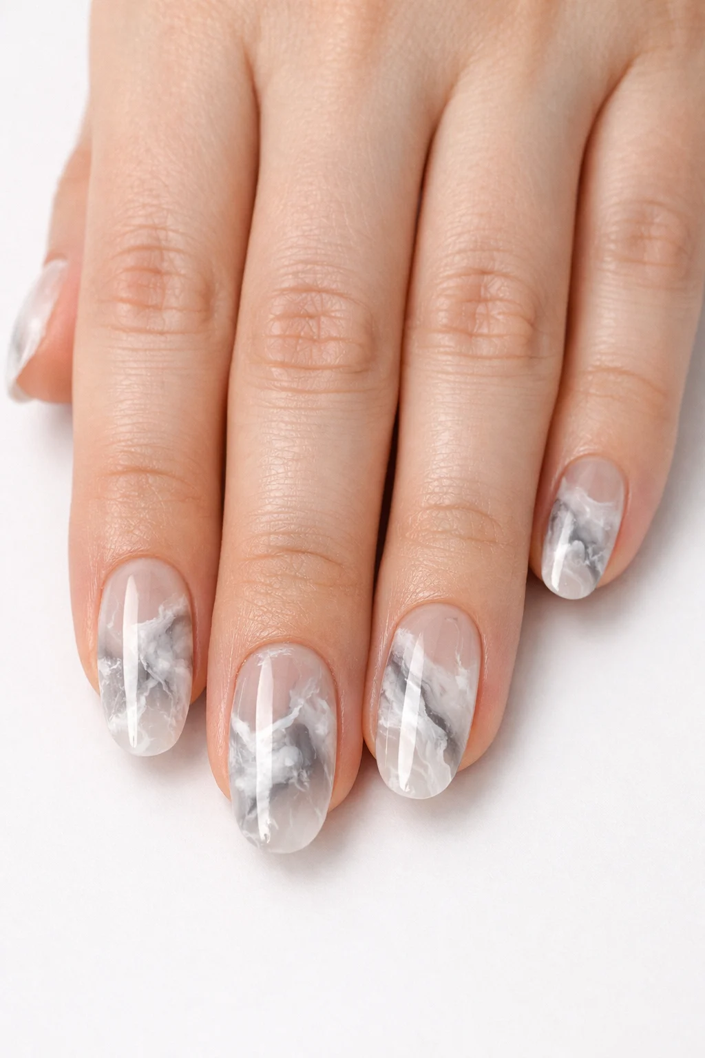 Soft gray marble blooming gel nail art with smoky nude base glossy finish