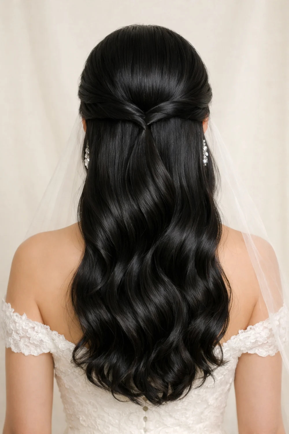 sleek twisted half up half down wedding hairstyle with glossy waves