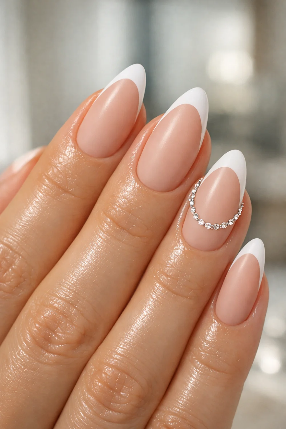 matte nude french tip nails with peach marble accent nail design and crystal curve detail on almond shaped manicure trendy matte nail inspiration