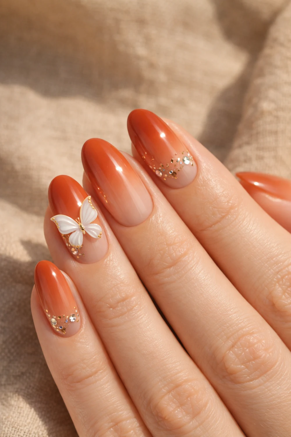 burnt orange ombre nails with butterfly and crystals autumn nails
