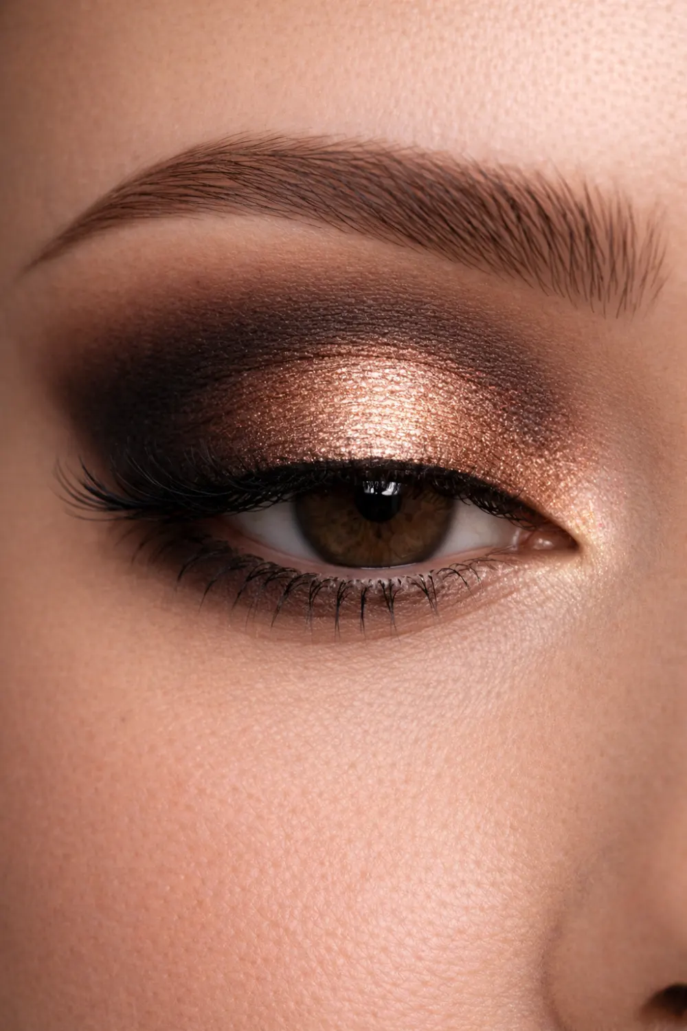 Bronze halo eyeshadow look for brown eyes close up with bright shimmer center lid and deep brown outer corners glam makeup