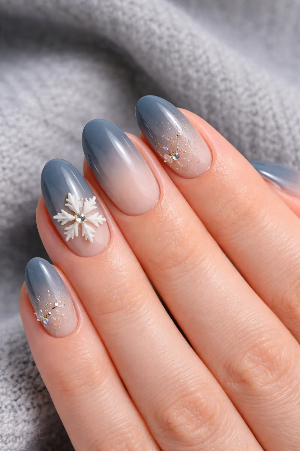 smoky blue ombre nails with snowflake and glitter winter nails