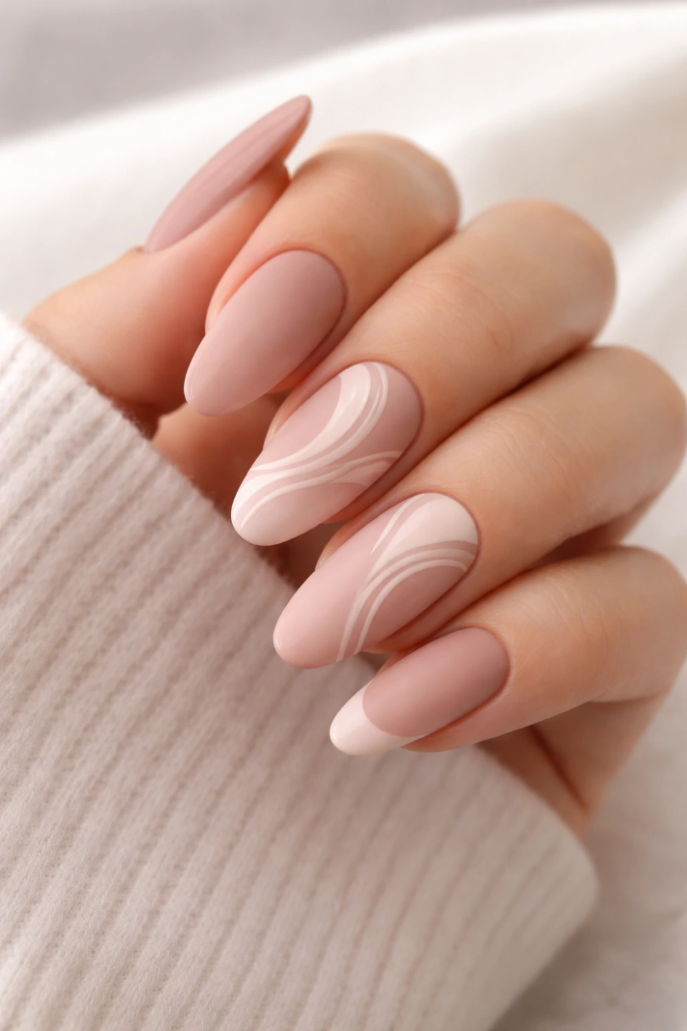 matte soft pink almond nails with minimal swirl nail art design elegant feminine manicure inspiration