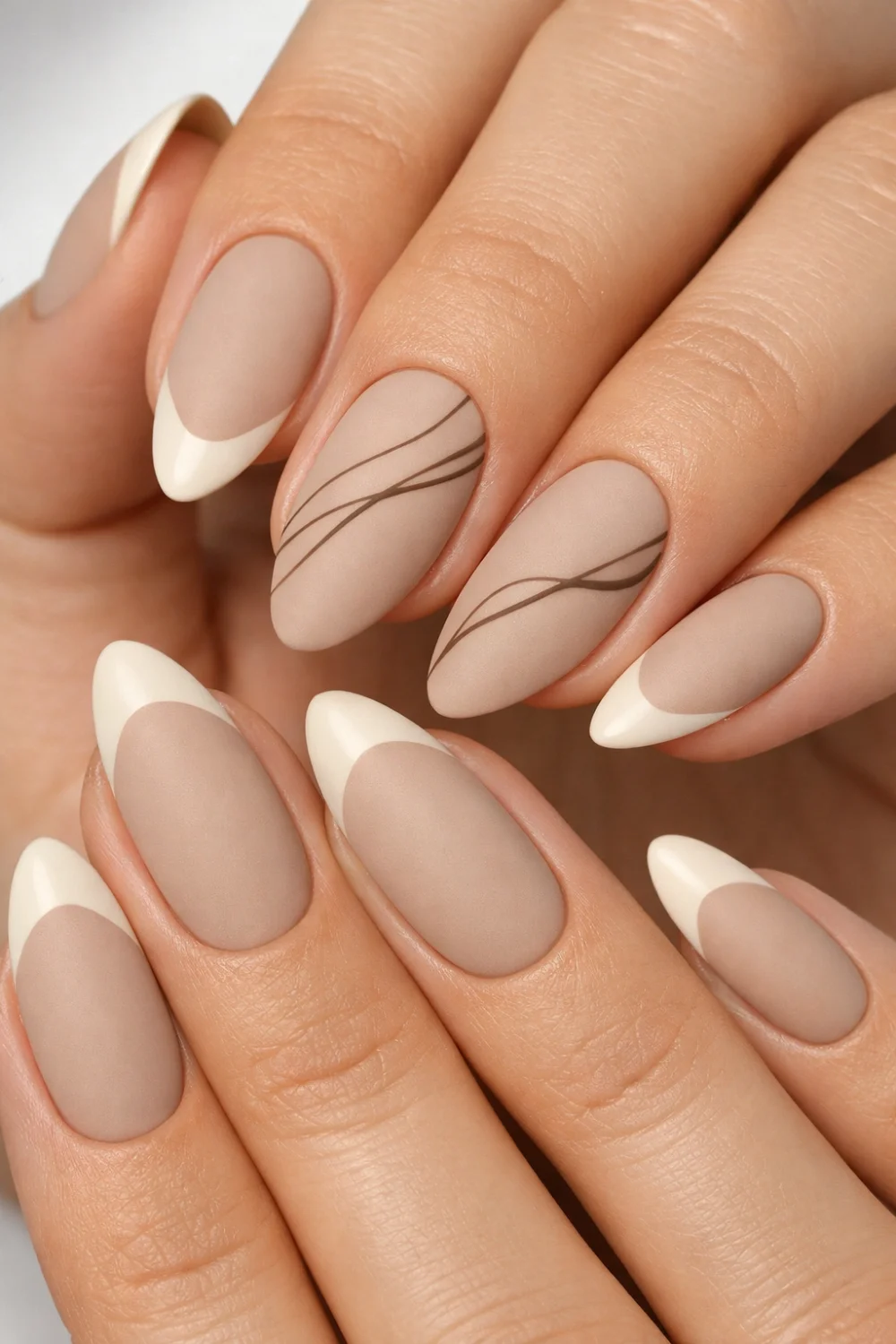 matte taupe almond nails with minimal line nail art and french tips modern neutral manicure inspiration