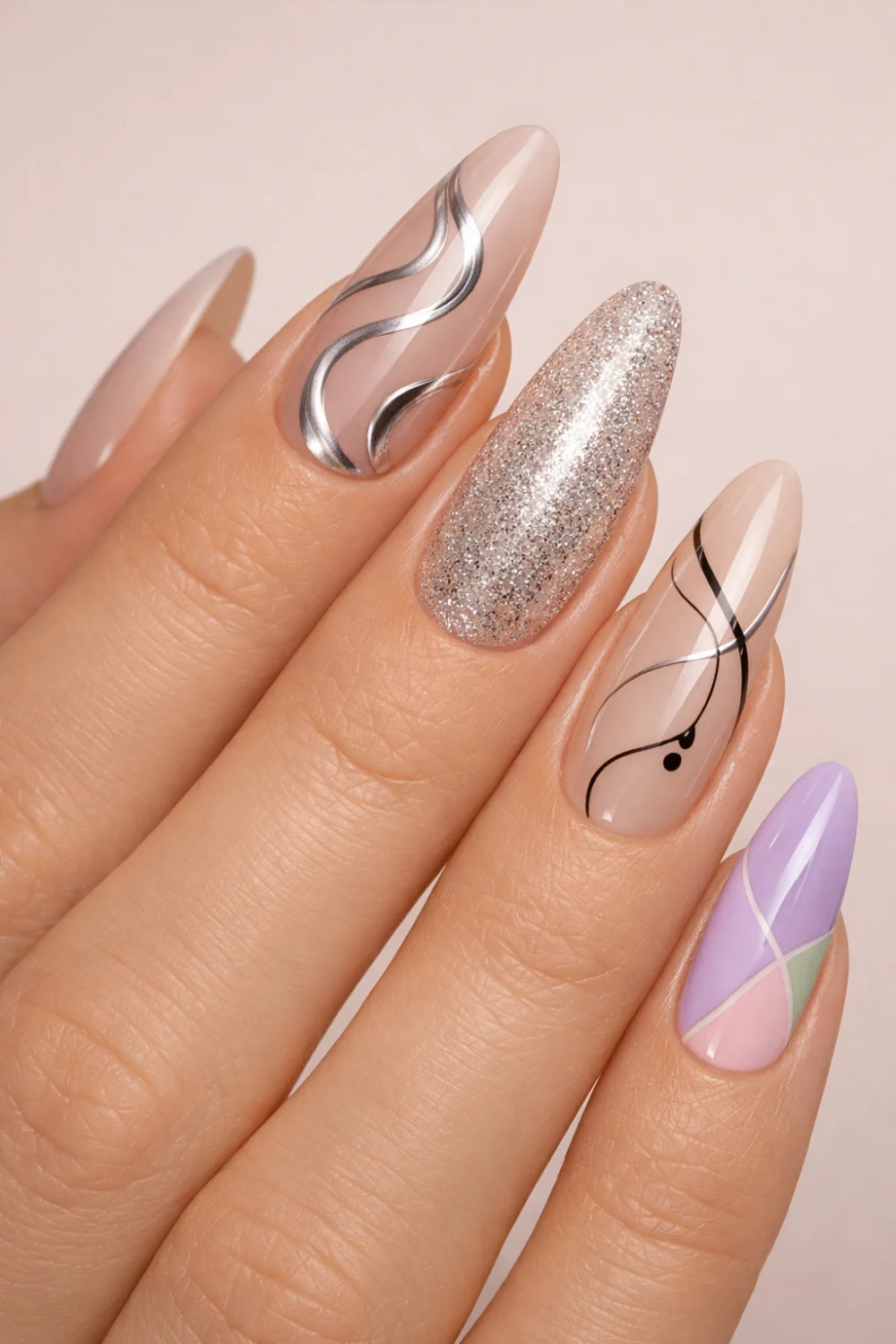Mixed design acrylic nails featuring chrome lines, glitter accent nail, abstract nail art and pastel colors creating a stylish creative manicure perfect for trendy nail inspiration.