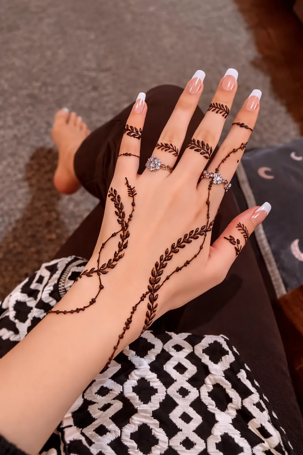 delicate leafy vine mehndi design flowing across fingers and hand minimal henna pattern elegant simple mehndi style