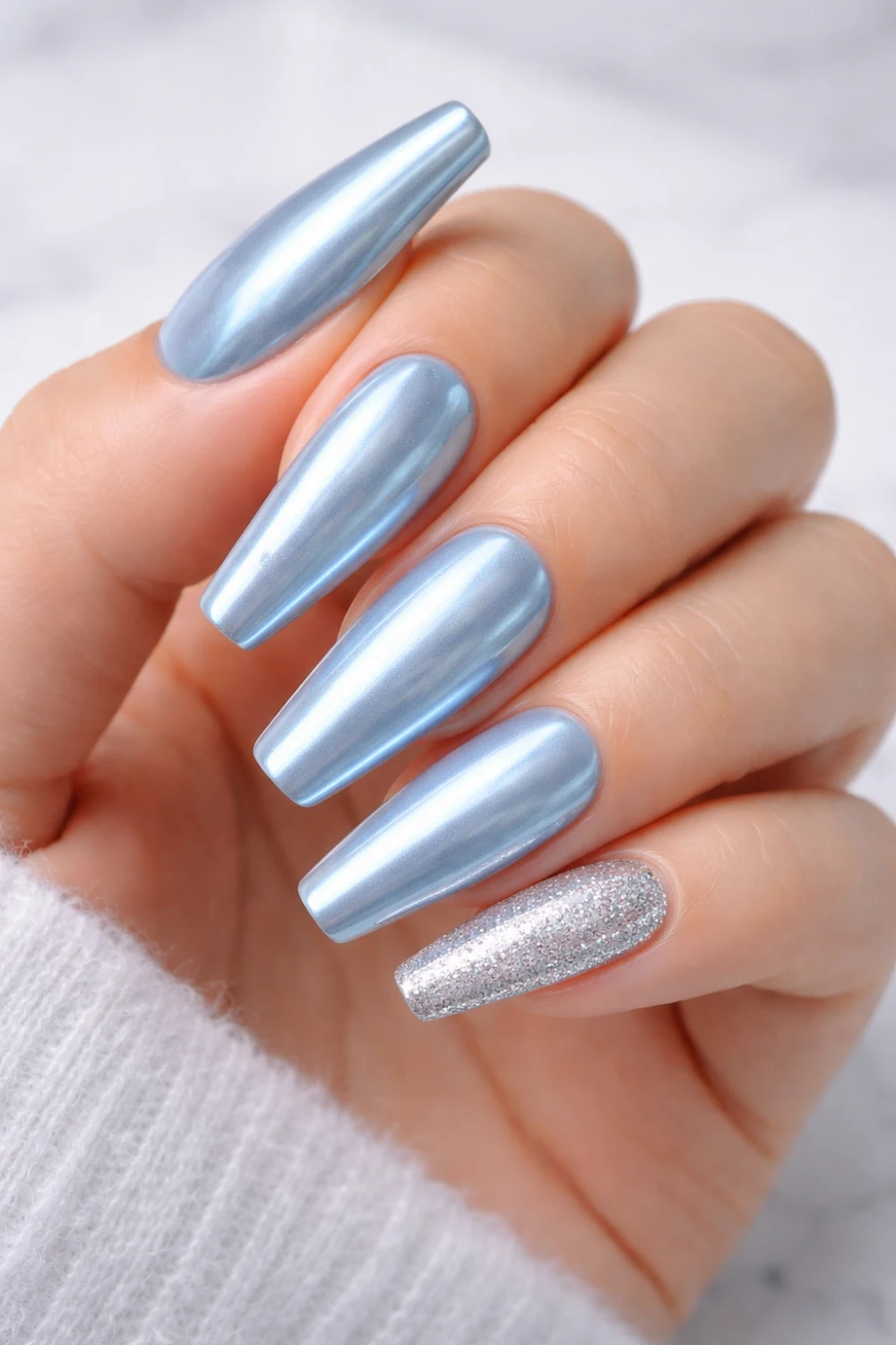 icy blue chrome ombre nails with glitter accent metallic almond nails trend