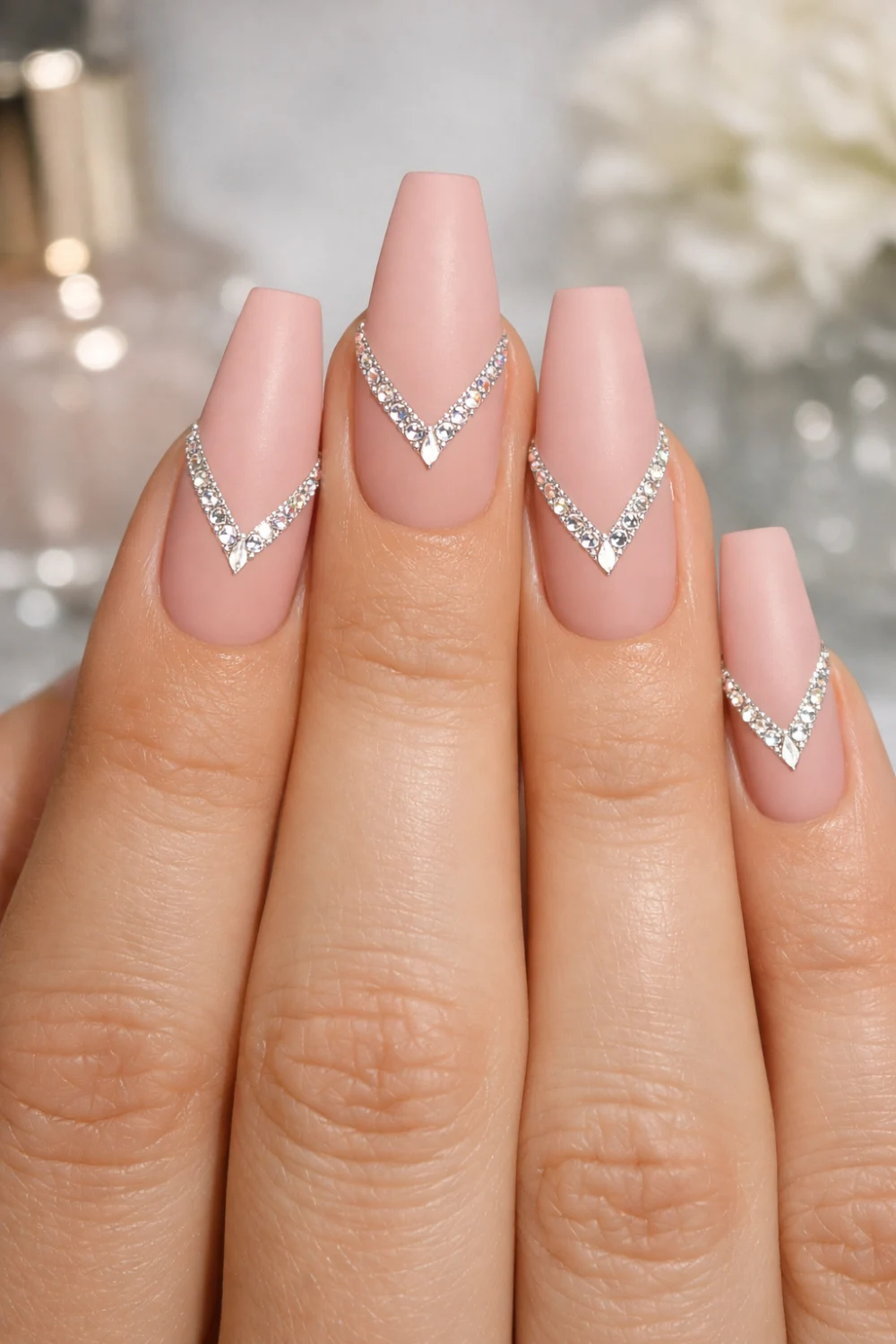 matte nude almond nails with v shaped crystal nail art design luxury minimalist manicure inspiration for elegant matte nail styles