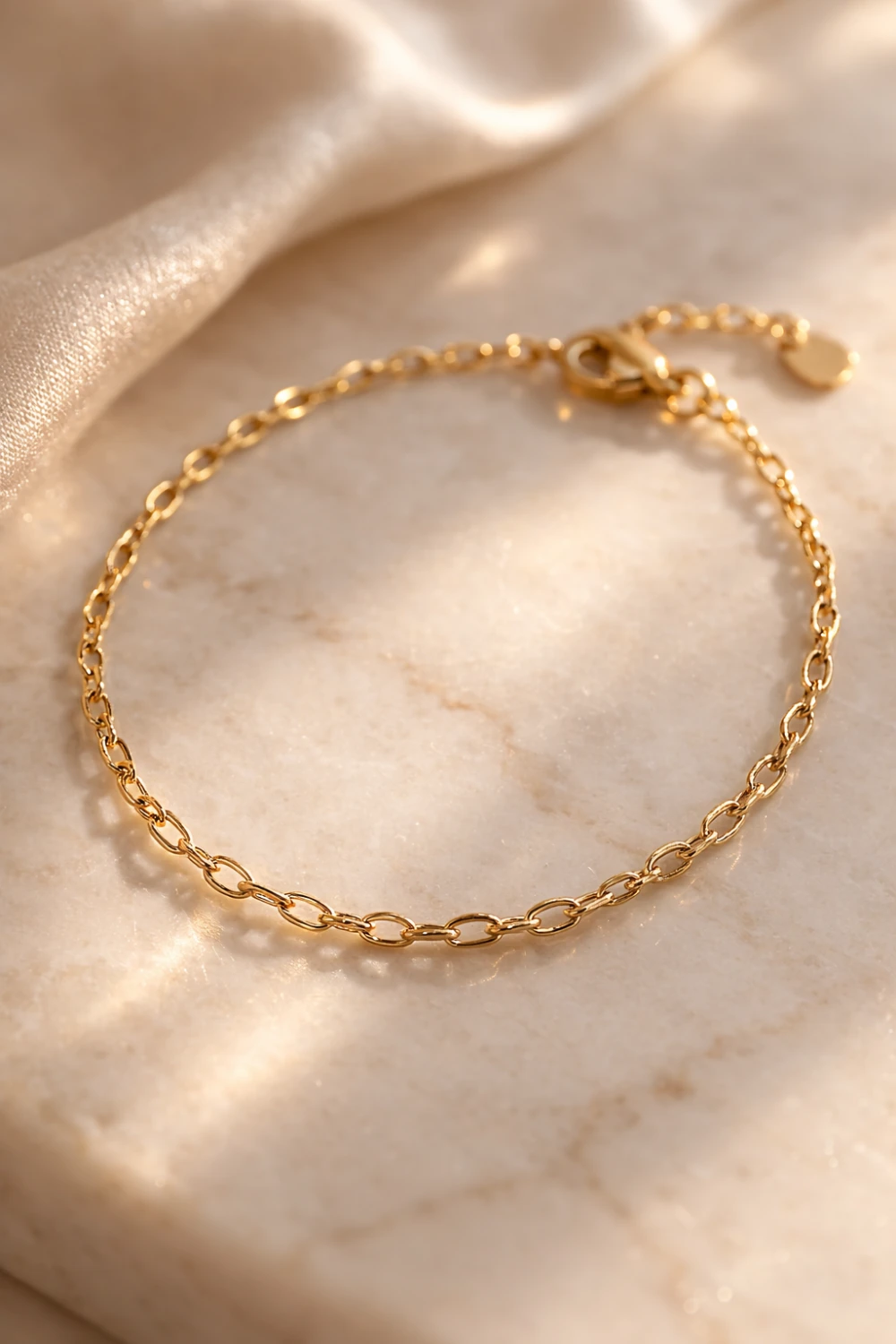 minimal gold chain bracelet elegant thin gold bracelet for women timeless old money style jewelry placed on marble surface with luxury lighting