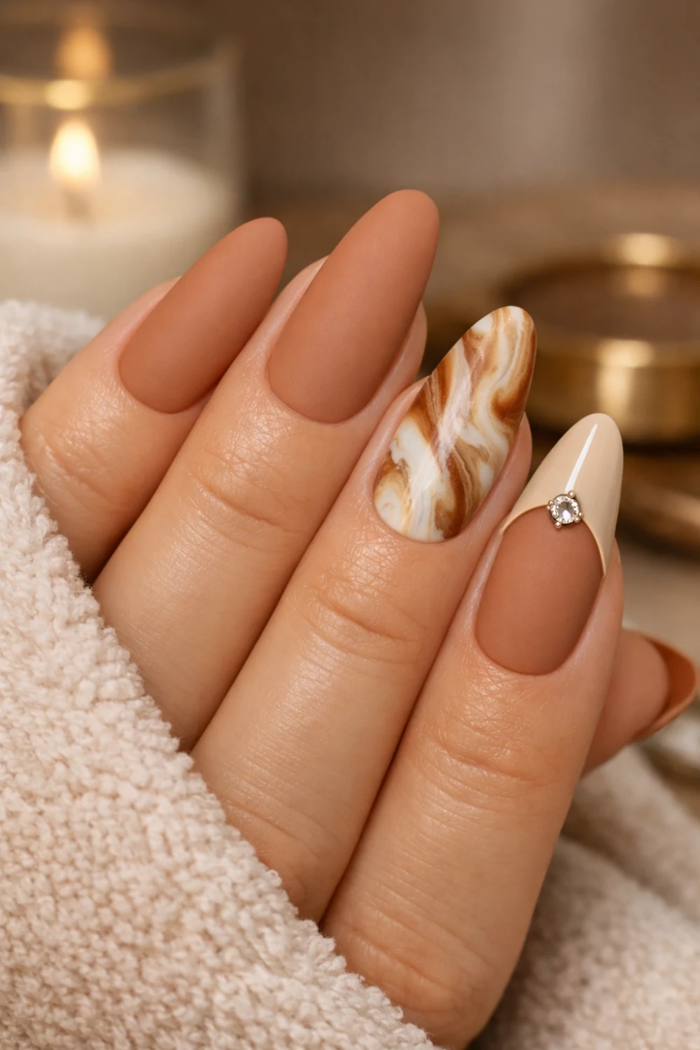 matte mocha brown almond nails with marble accent nail design and minimal crystal detail elegant neutral manicure inspiration