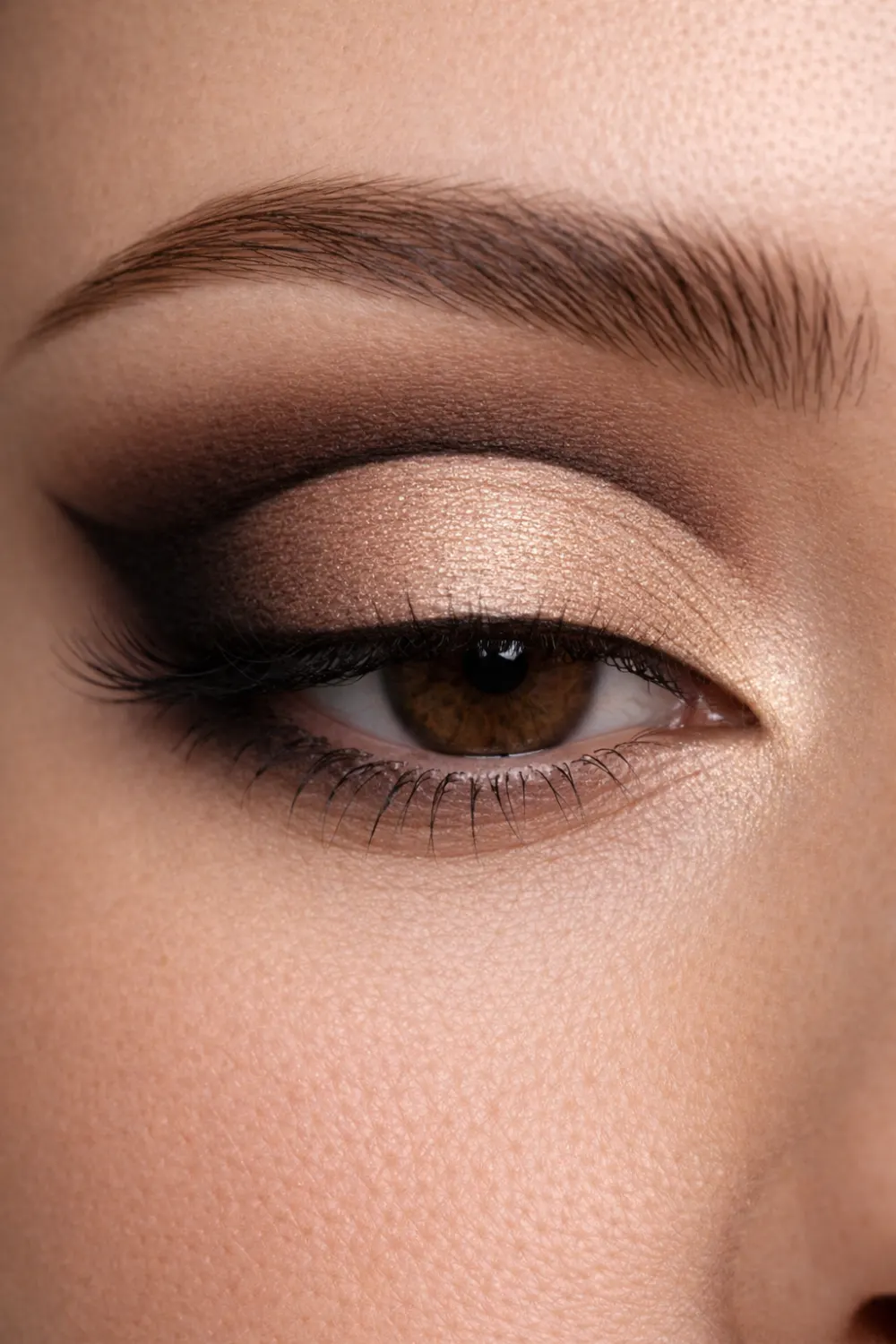 Neutral brown glam eyeshadow look for brown eyes close up with champagne lid and deep brown crease blended classic eye makeup
