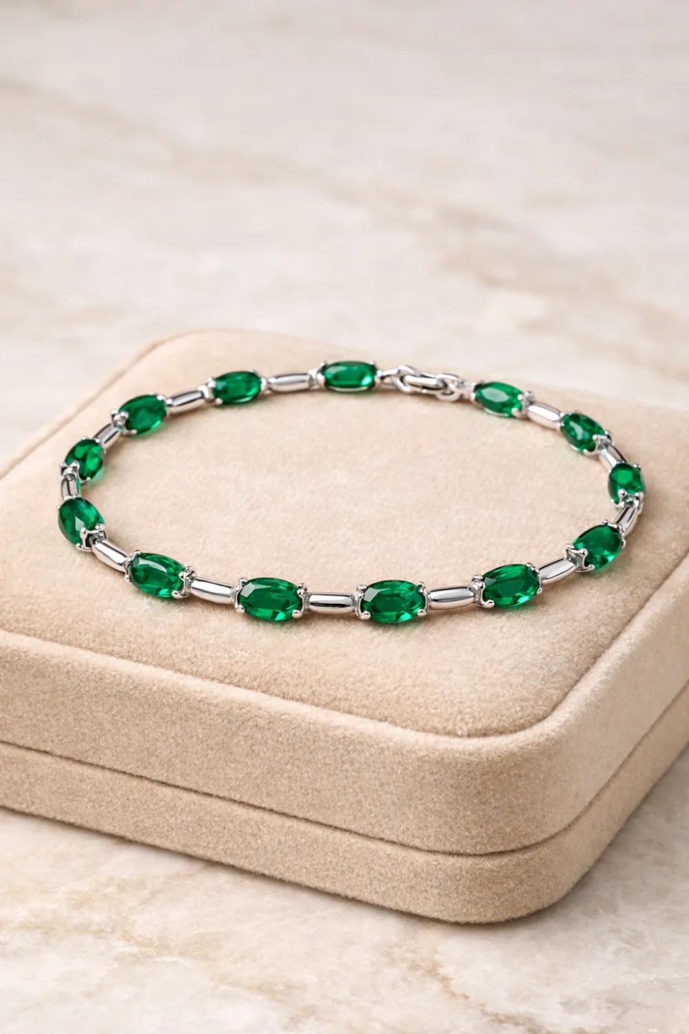 emerald link bracelet elegant green gemstone bracelet with polished silver links luxury women's jewelry displayed on velvet jewelry box