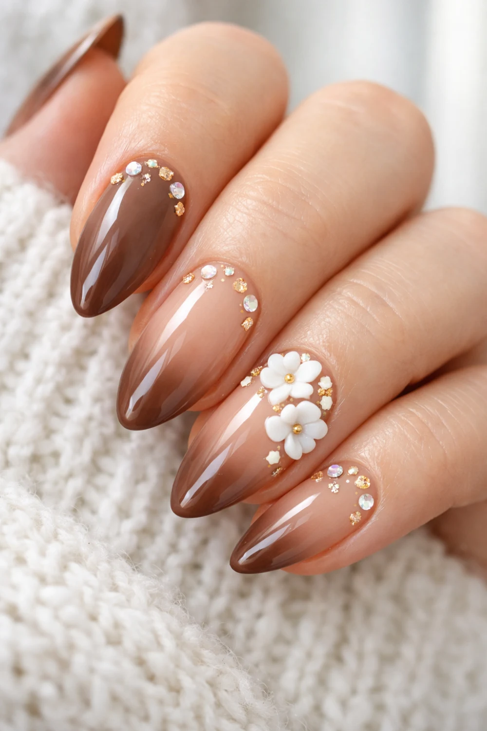 nude to brown ombre nails with floral art and crystals almond nails