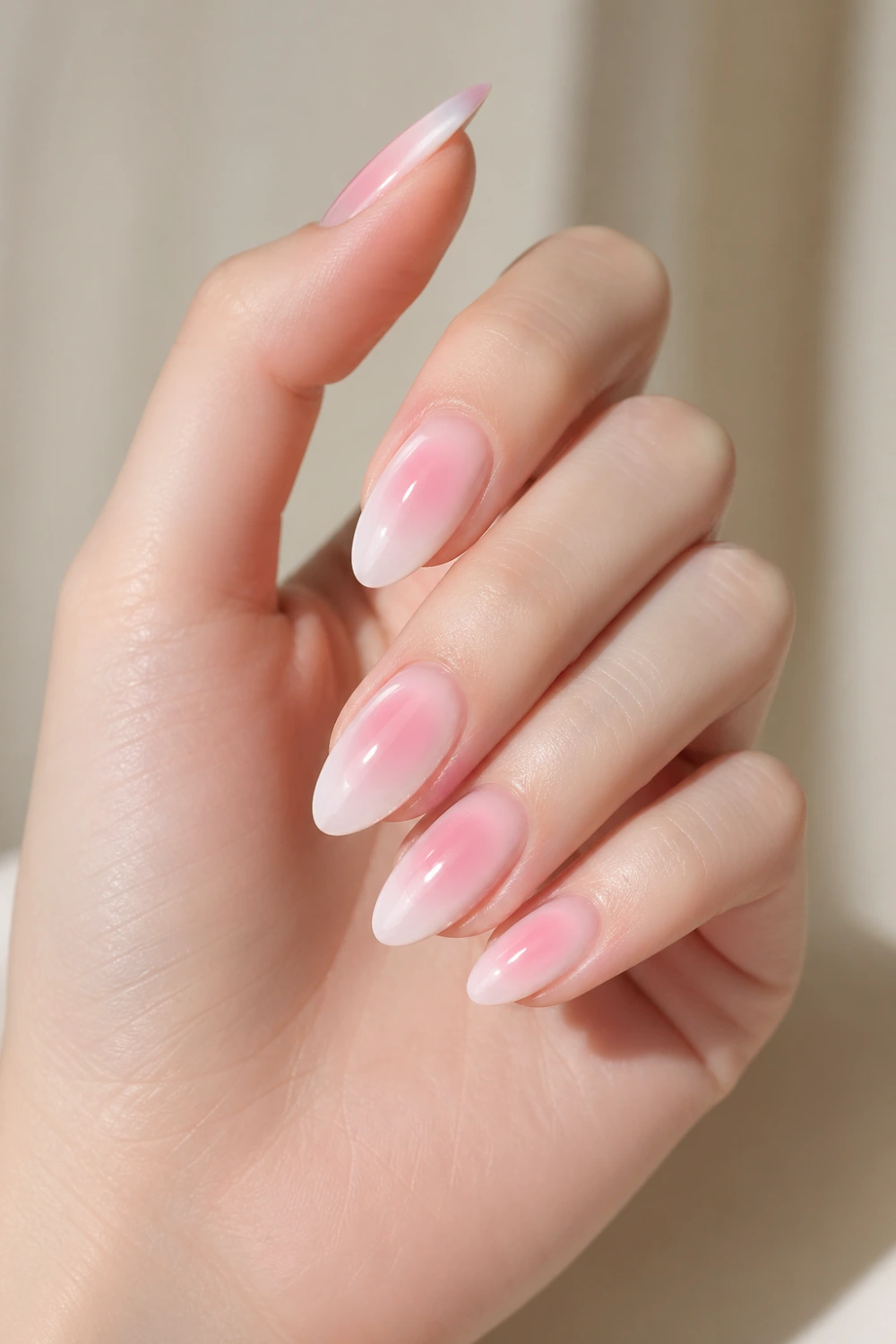 soft pink milky halo nails glossy almond gel nails soft aura gradient pink center fade into milky white edges clean minimal manicure elegant feminine nail design everyday glam trending nails pinterest style