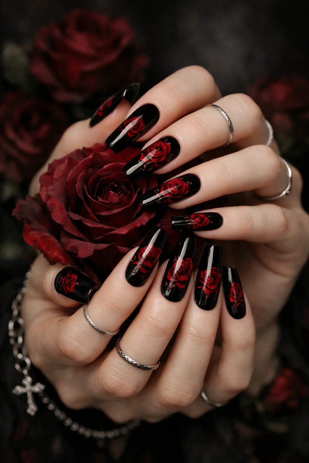 Black coffin nails with red rose nail art, romantic gothic manicure featuring floral dark glam design on long coffin shaped nails perfect for gothic beauty inspiration.