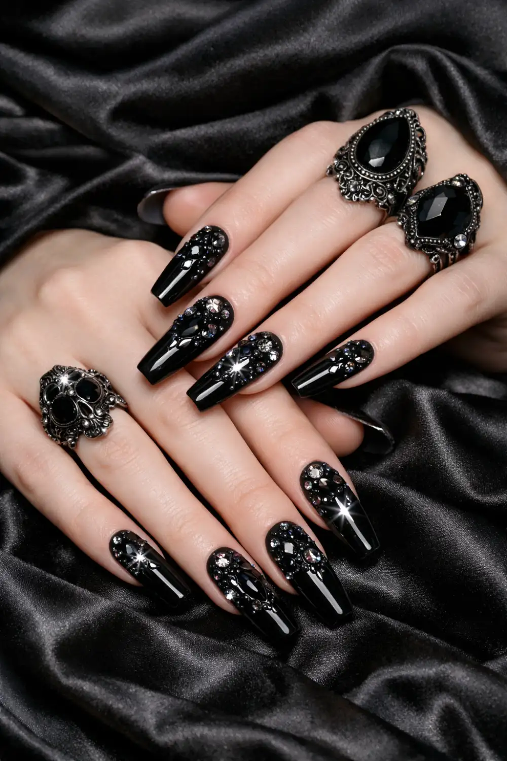 Black rhinestone gothic coffin nails with sparkling crystals on glossy black manicure, luxurious dark glam nail design perfect for edgy gothic nail inspiration.