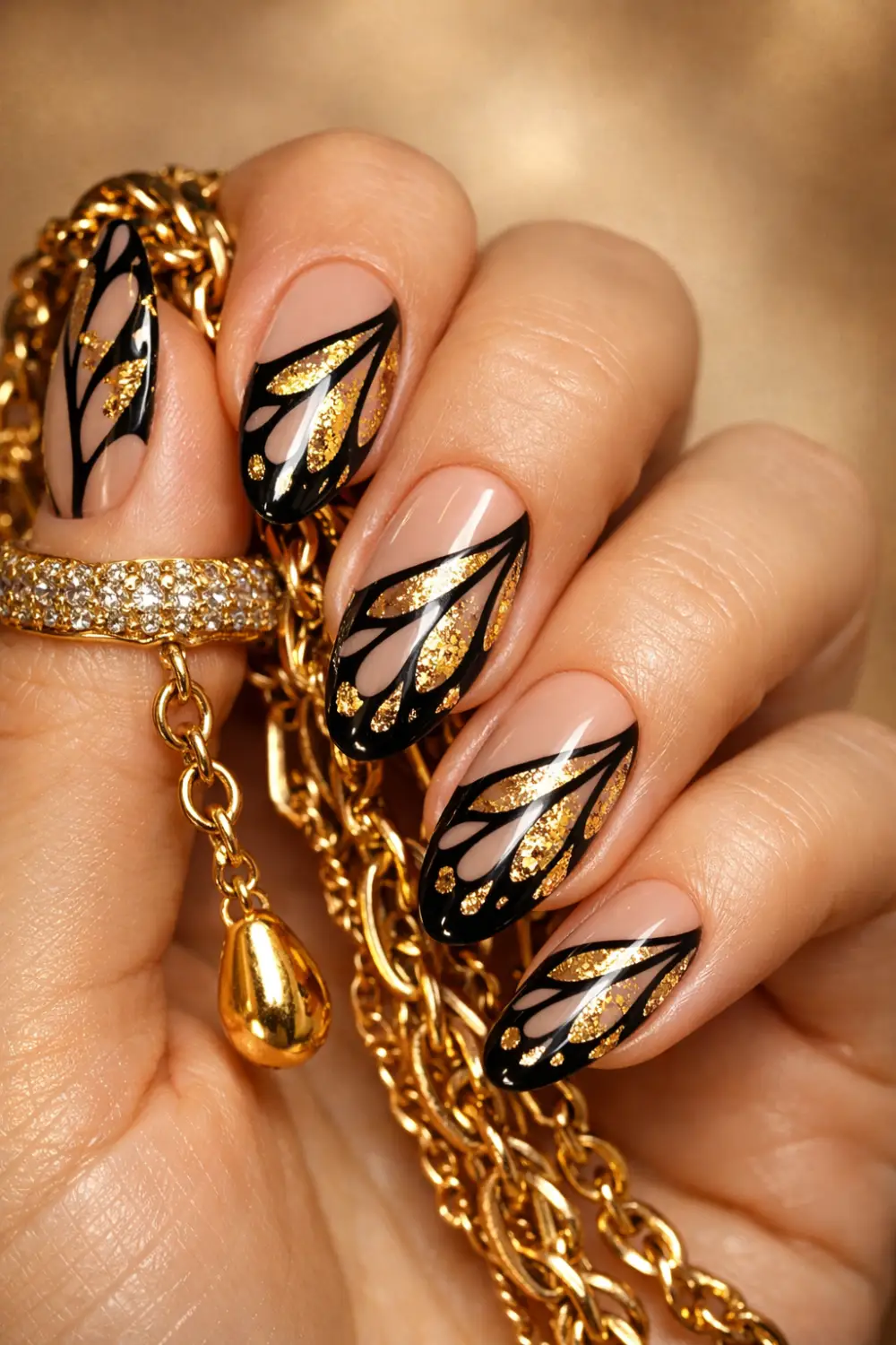 Full female hand on sandy beach surface showing sunset butterfly wing nail art with coral orange and yellow colors glossy gel manicure inspiration