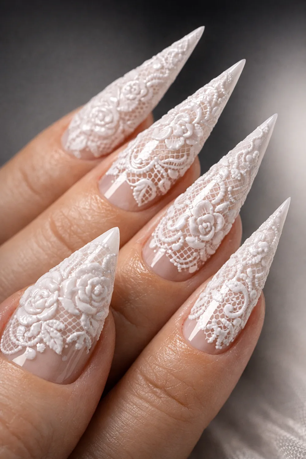 3D lace nail design with raised textured floral lace patterns on long stiletto nails, elegant white sculpted manicure creating a dramatic couture lace nail look perfect for statement nail inspiration and luxury nail art