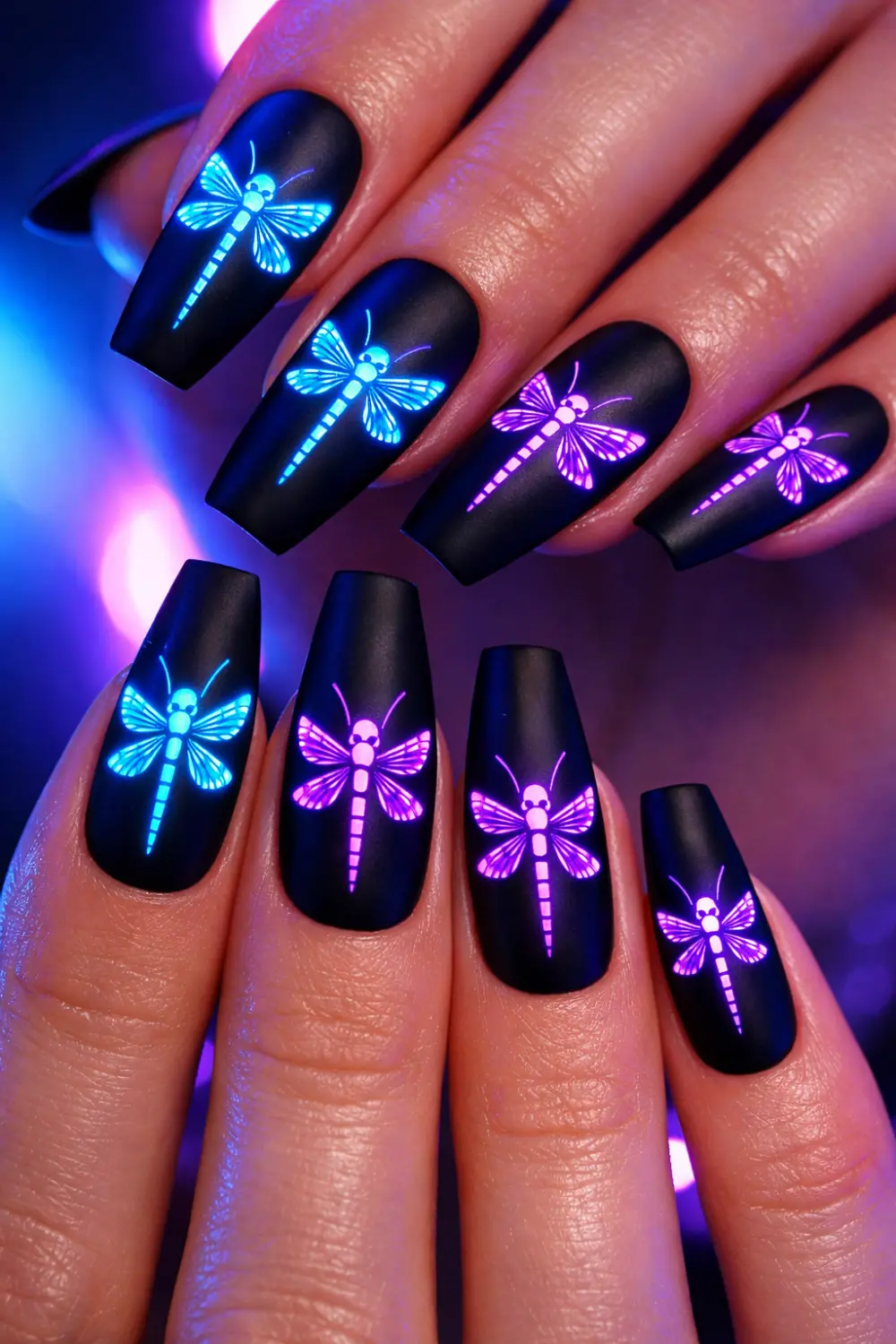 neon dragonfly nail art glowing design on matte black nails futuristic manicure