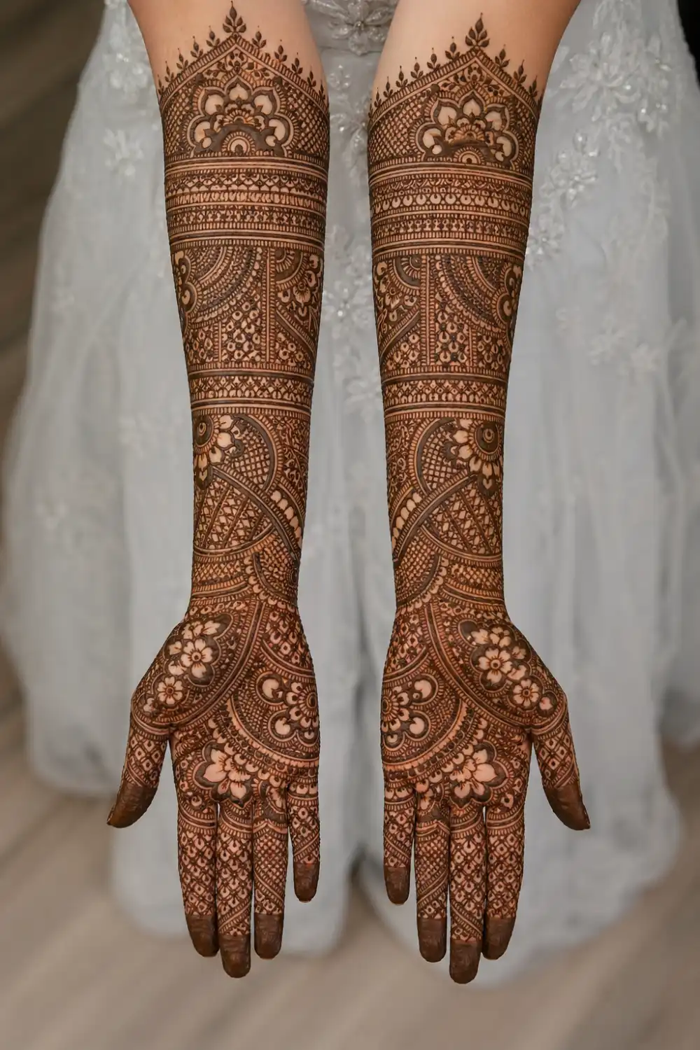 full coverage symmetrical bridal mehndi design with dense paisley and floral patterns on both hands, intricate detailing, dark fingertips, complete traditional henna from fingers to elbow