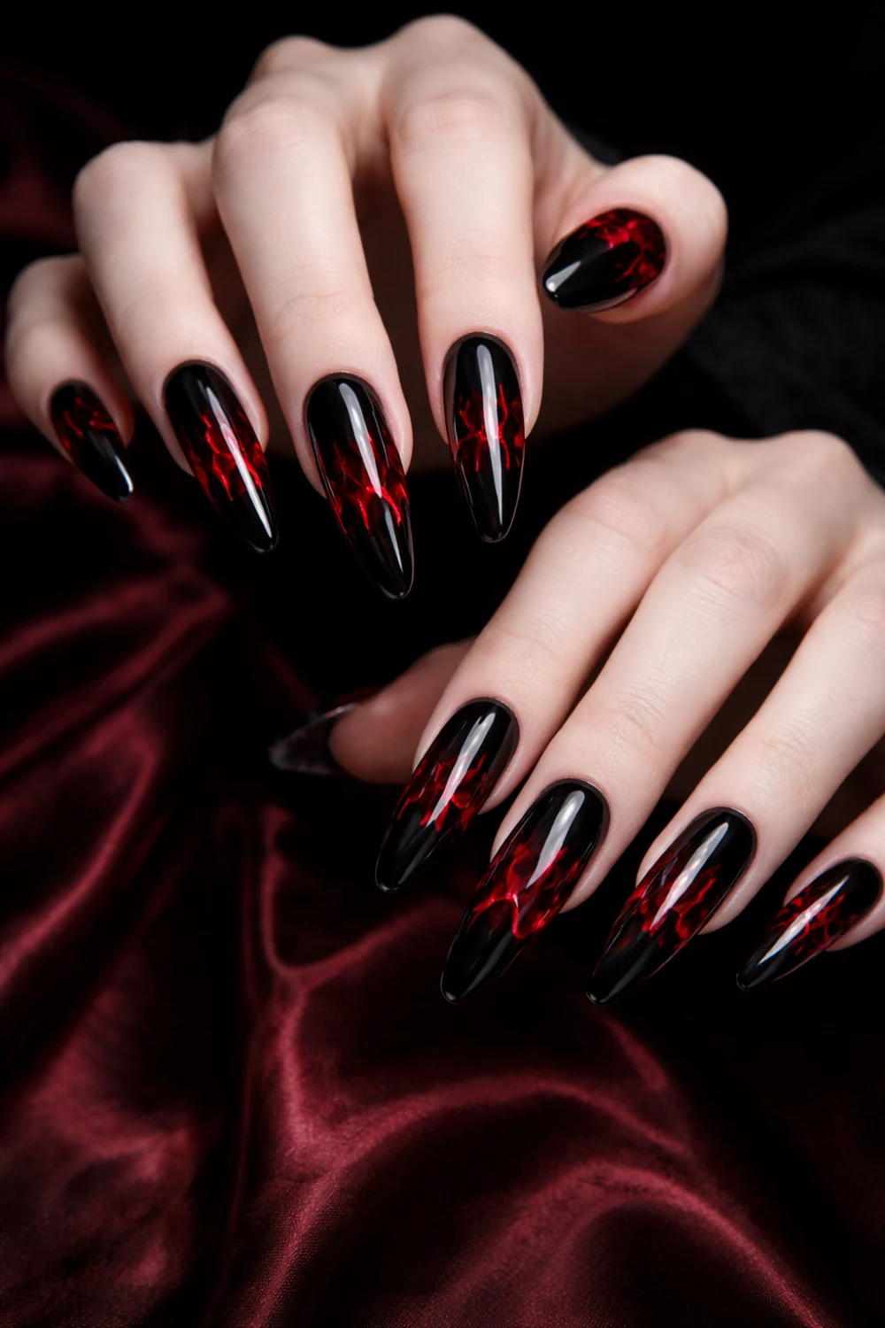 Black and red gothic flame coffin nails with glossy finish, dramatic dark glam manicure featuring fiery red accents on long coffin shaped nails perfect for edgy nail art inspiration.