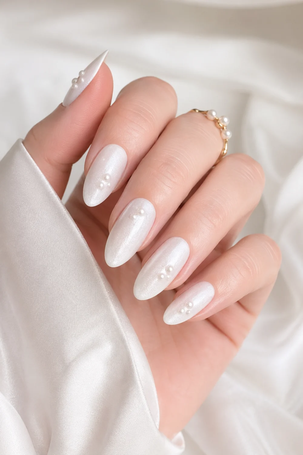 pearl milk bath nails glossy white milky base small pearl accents luxury bridal nails soft shimmer almond shape nails elegant feminine manicure