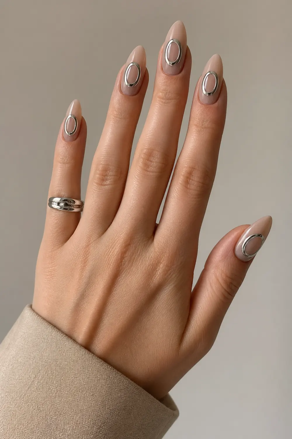 nude chrome halo ring nails glossy almond gel nails minimal nude base metallic silver oval ring design modern luxury manicure clean aesthetic nails