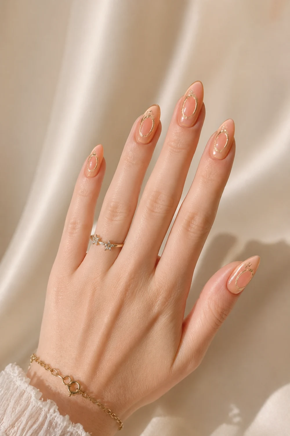 nude gold halo ring nails glossy almond gel nails soft nude base gold metallic halo accents elegant feminine manicure luxury minimal nail design