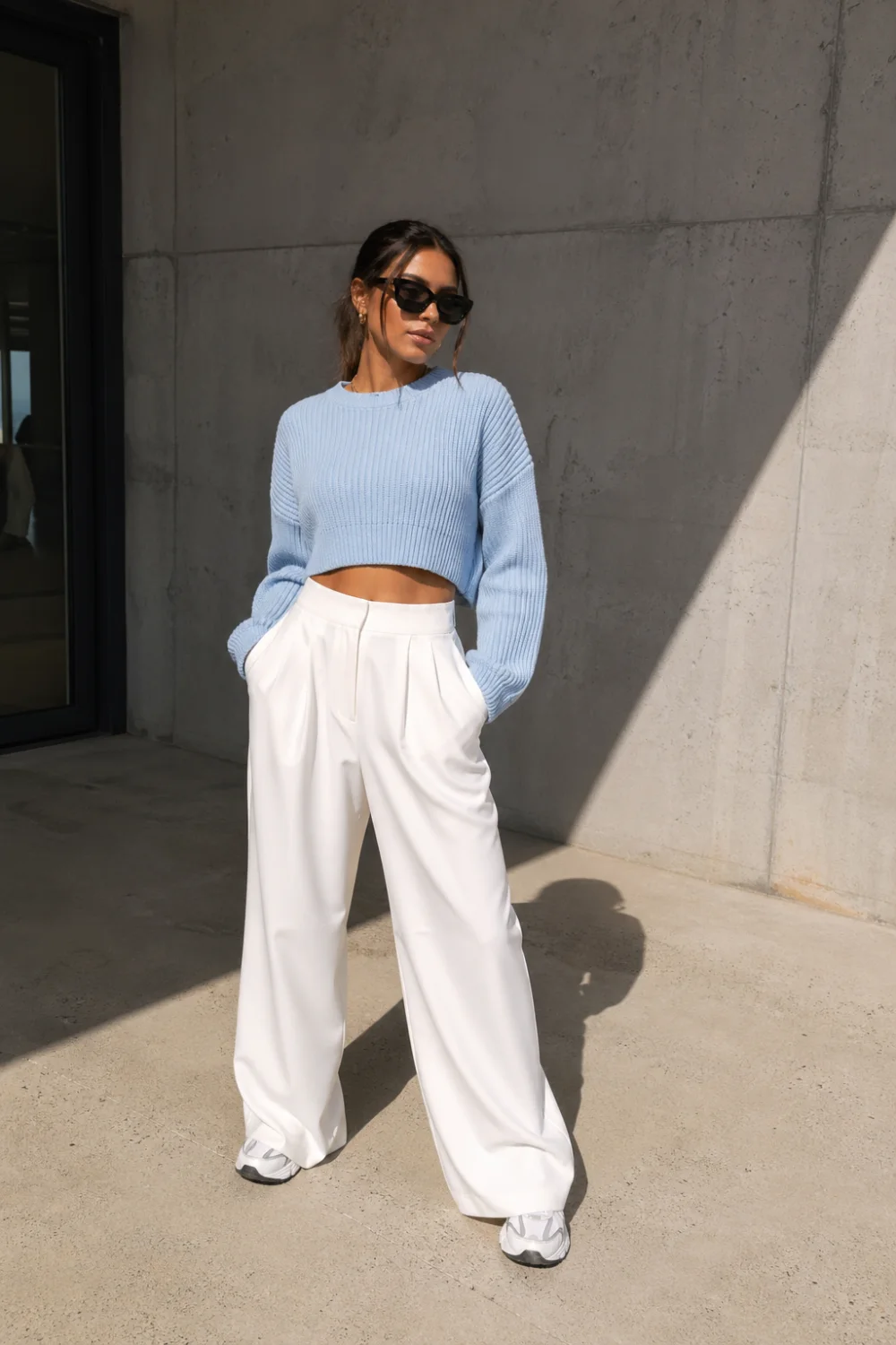 ice blue crop sweater outfit with white wide leg pants, minimal clean fashion look, modern casual outfit aesthetic, pastel blue knit top styling, street style outfit idea