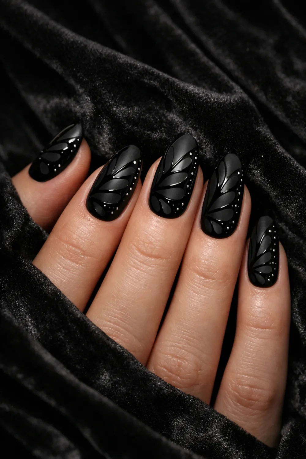 Full female hand holding sunglasses showing neon butterfly wing nail art in bright pink orange and yellow colors, glossy gel manicure vibrant butterfly nail inspiration