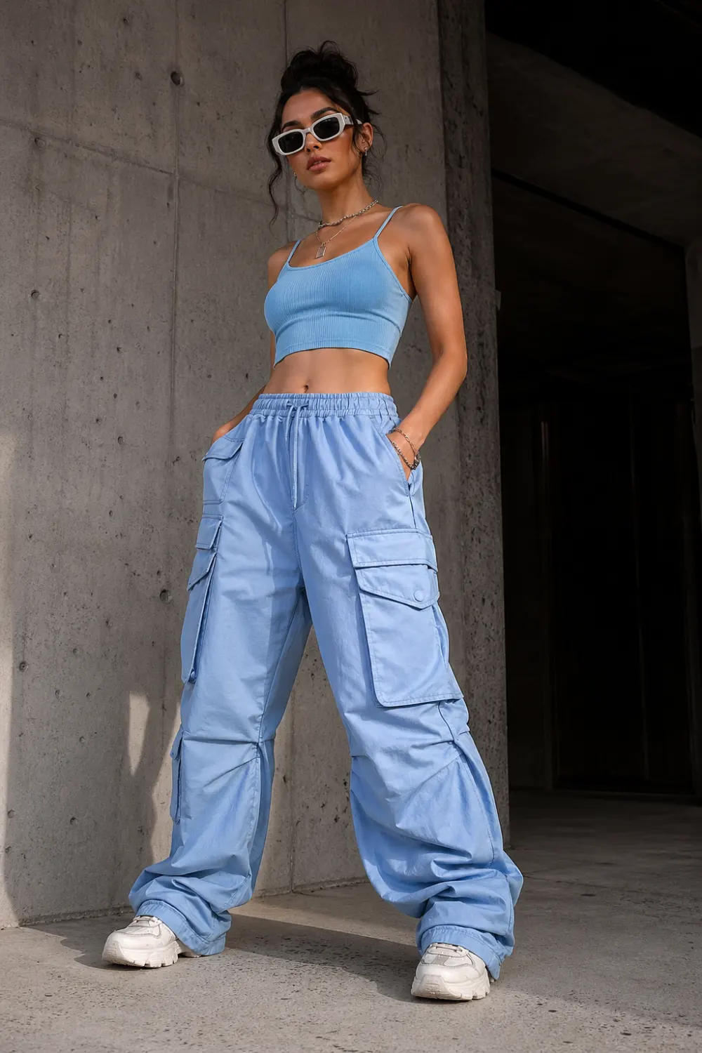 ice blue cargo pants outfit with crop top, streetwear fashion style, oversized pants aesthetic, edgy modern outfit idea, pastel blue casual trendy look