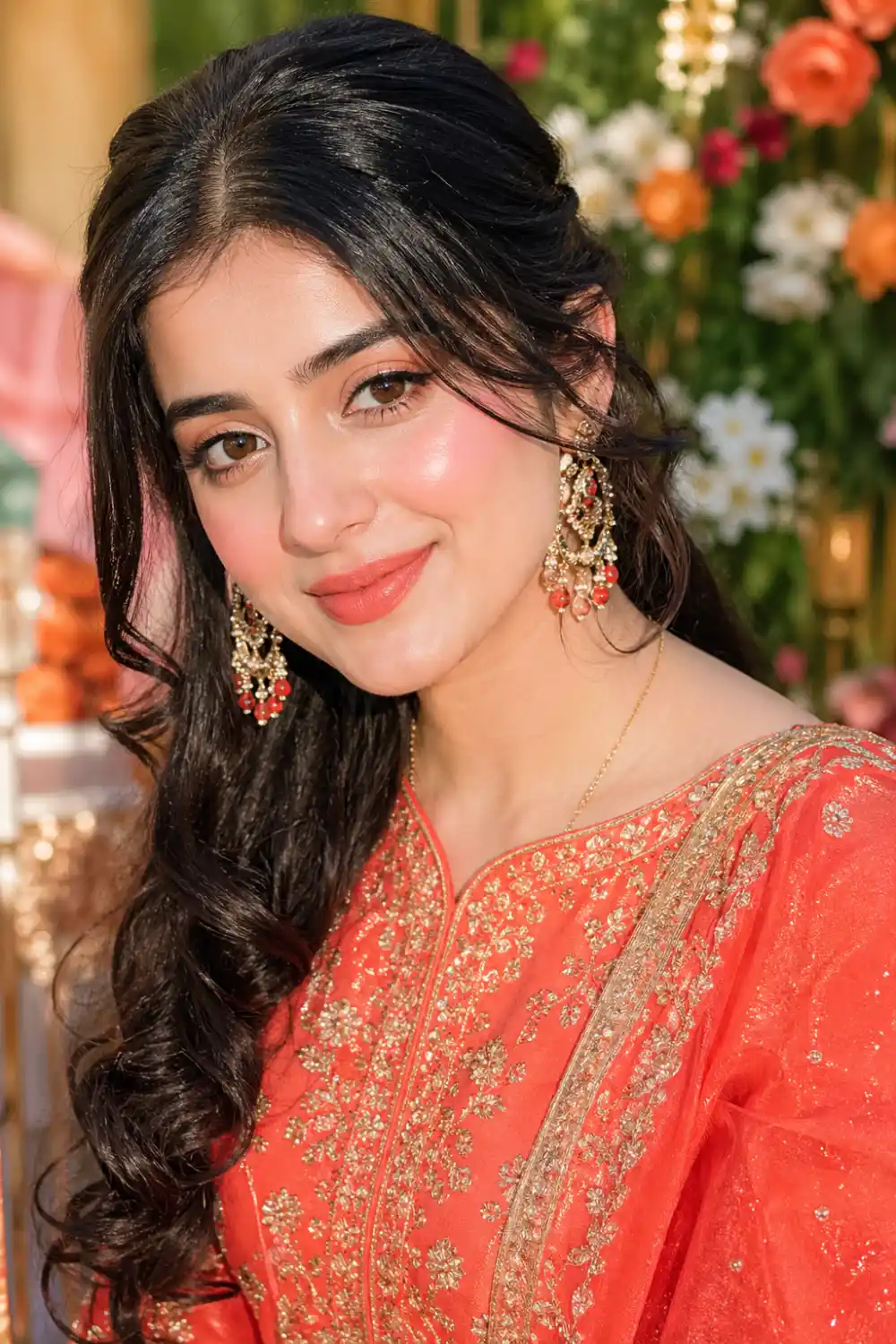 Coral blush bridesmaid makeup with fresh glowing skin, vibrant coral cheeks, glossy lips, festive bridal look, Pakistani bridesmaid portrait, bright soft glam