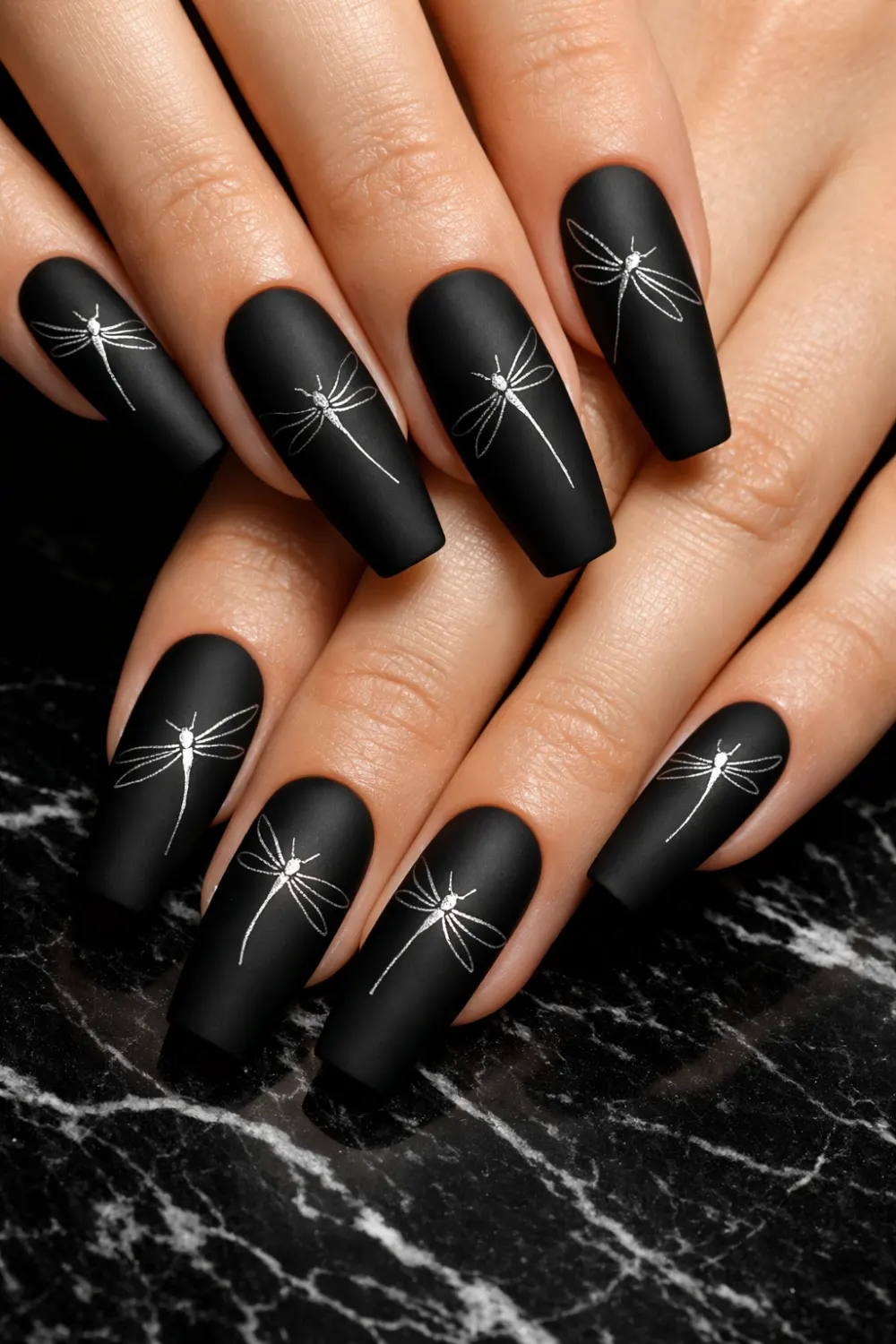matte black dragonfly nail art with white line design bold modern manicure inspiration