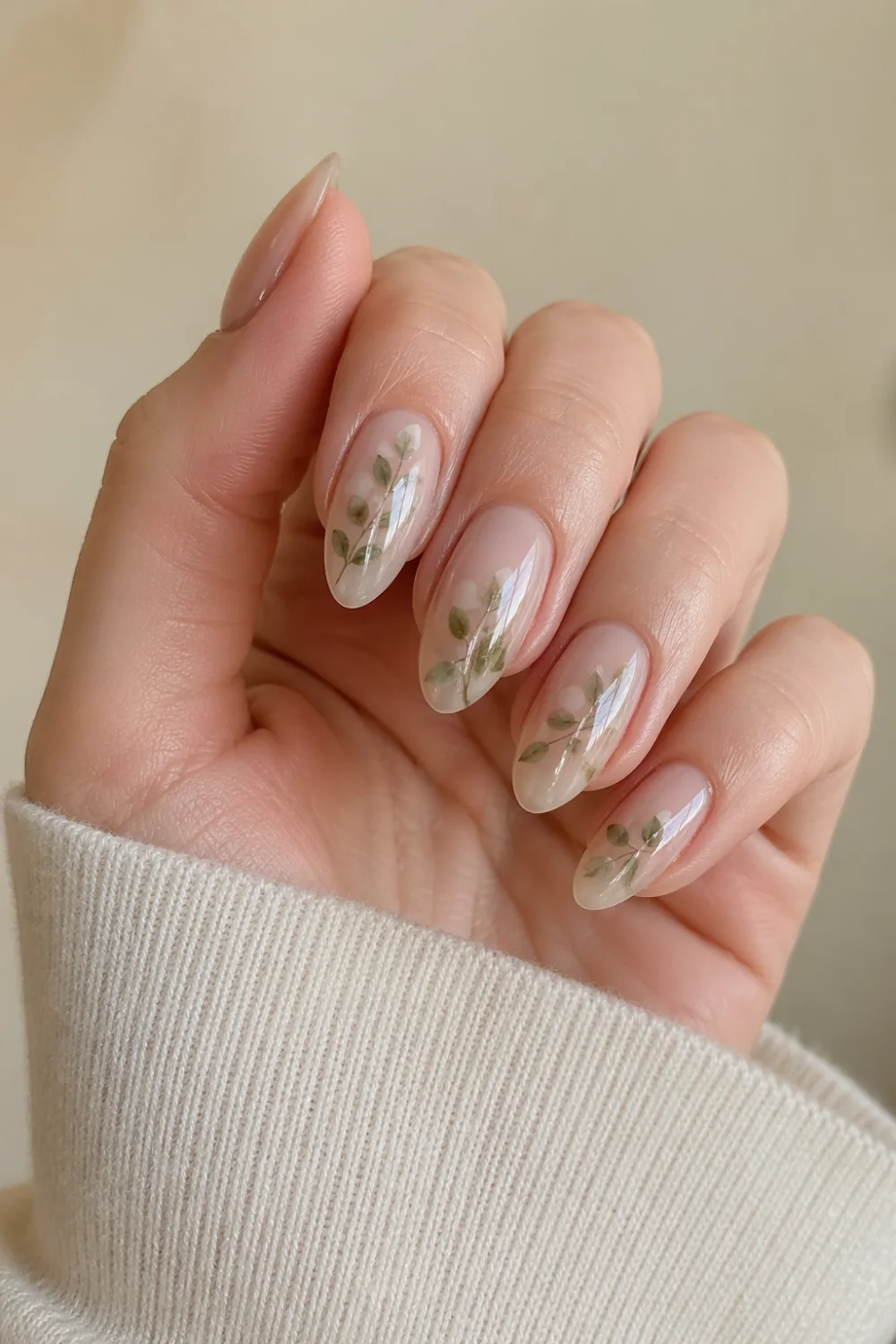 botanical milk bath nails green leaf design milky translucent base nature inspired nails glossy almond shape soft earthy aesthetic manicure
