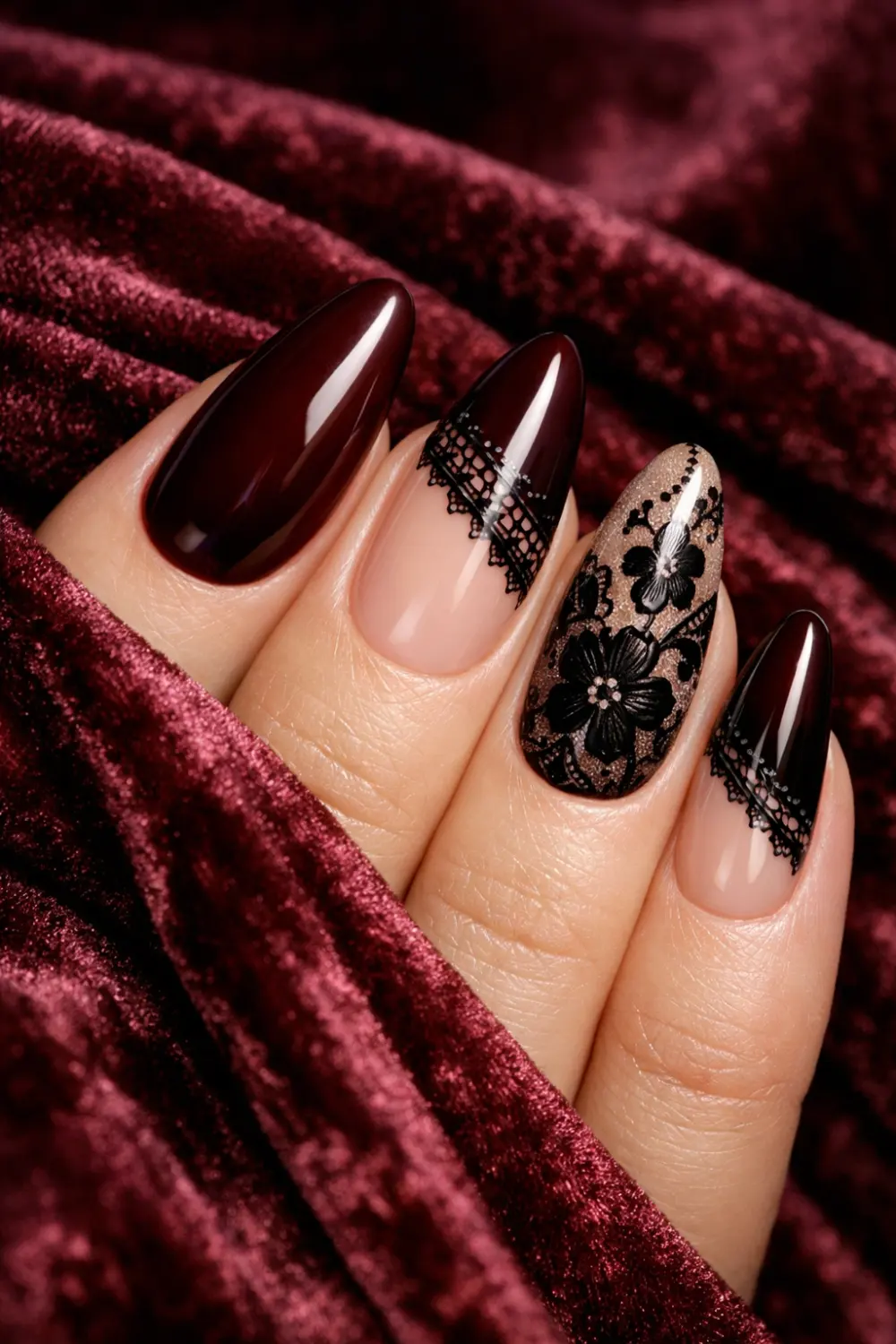 Deep burgundy manicure with elegant black lace nail art and floral lace patterns on almond shaped nails, rich glossy polish creating a dramatic luxurious lace nail design perfect for winter manicure inspiration