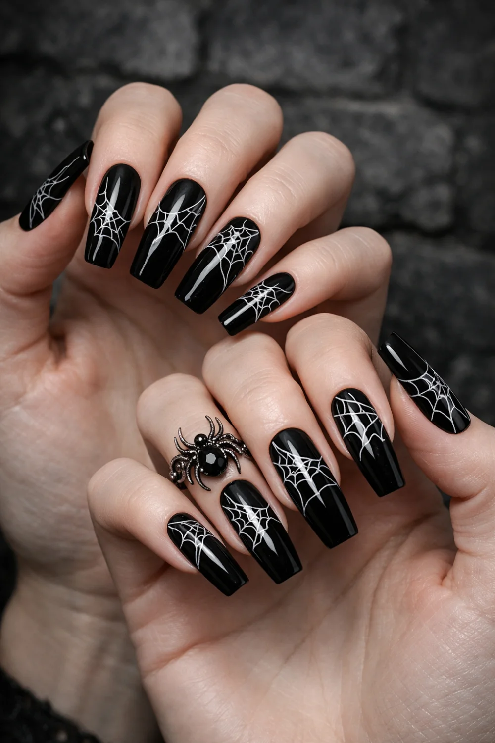 Gothic spider web coffin nails with white web nail art on glossy black nails, dramatic dark aesthetic manicure perfect for edgy gothic nail inspiration.