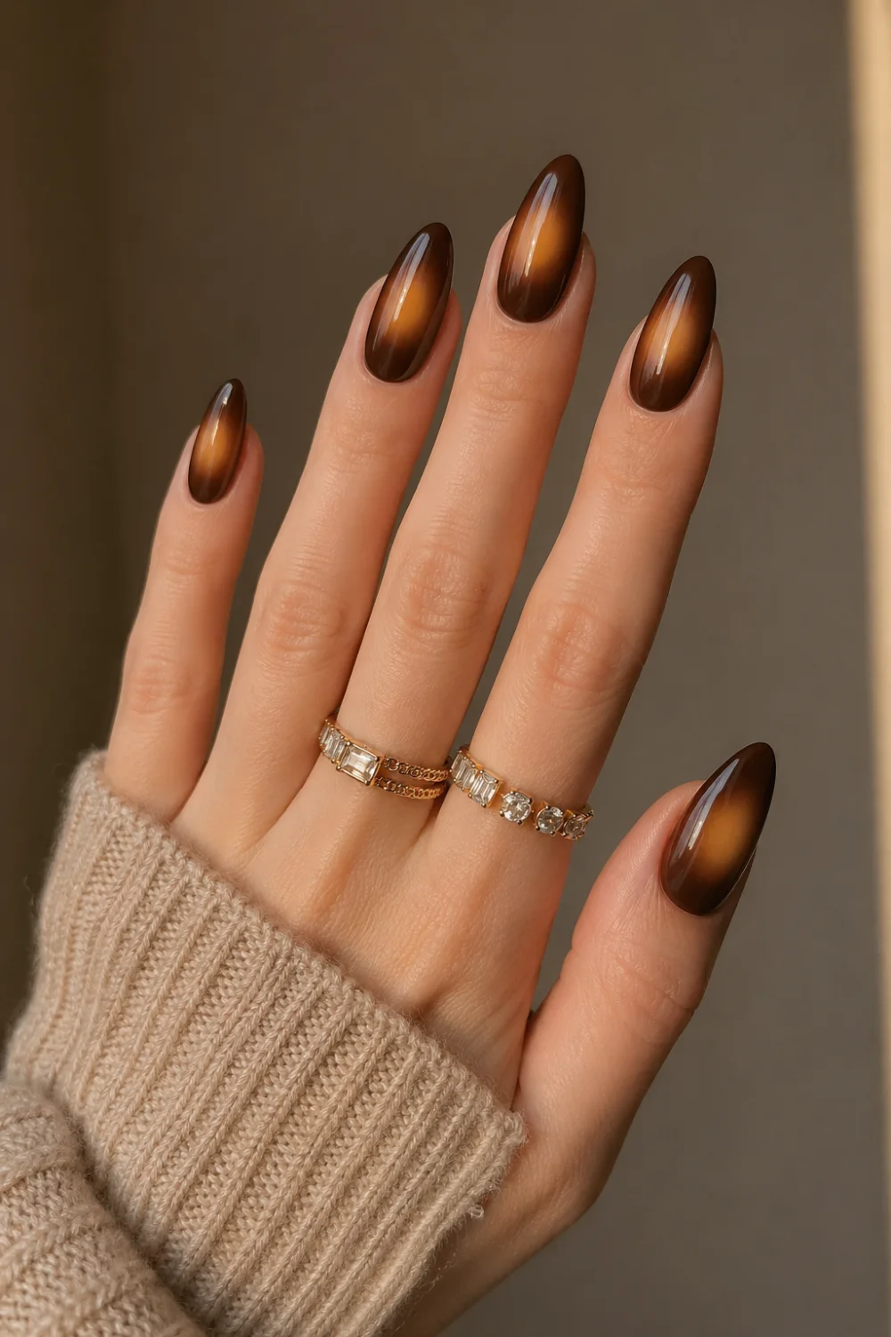 chocolate brown aura halo nails glossy almond gel nails deep brown base caramel glow center warm cozy nail design fall aesthetic manicure