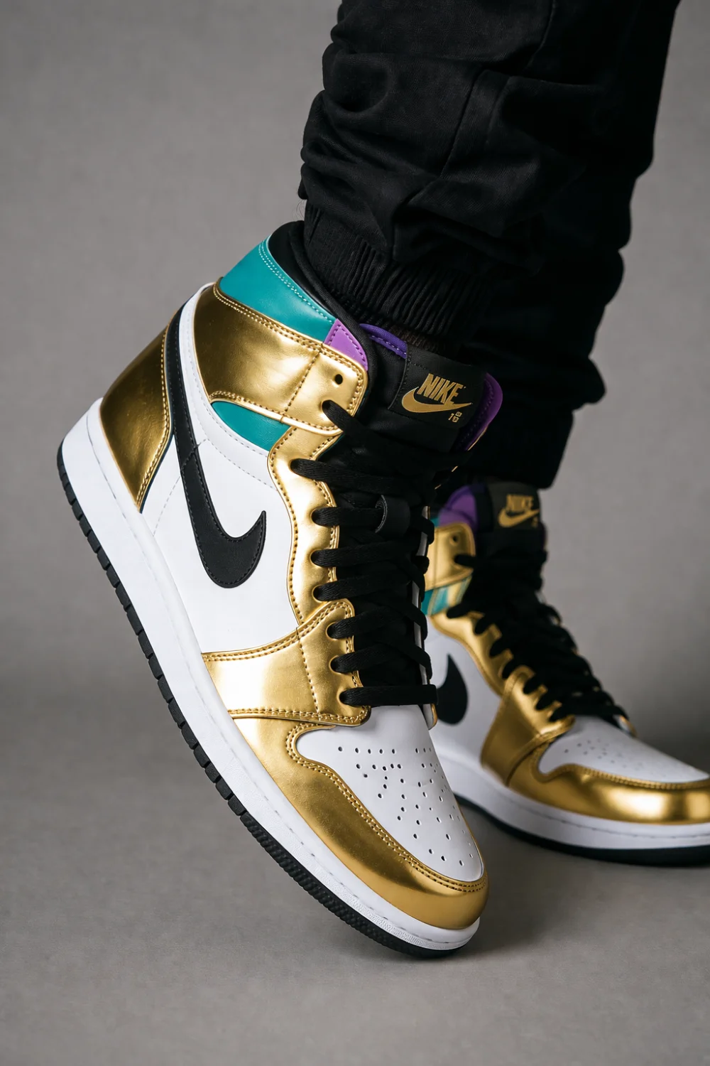 Metallic gold and multicolor sneakers with bold panels worn with black outfit, high contrast streetwear style, eye catching footwear design, modern fashion sneakers perfect for standout casual looks